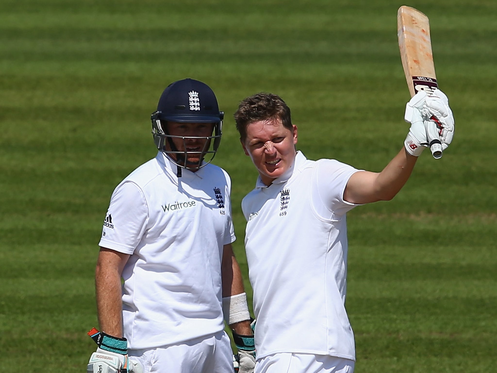 Gary Ballance (R) of England raises his bat after reaching his 150 alongside Ian Bell during day two of the 3rd Investec Test match between England and India