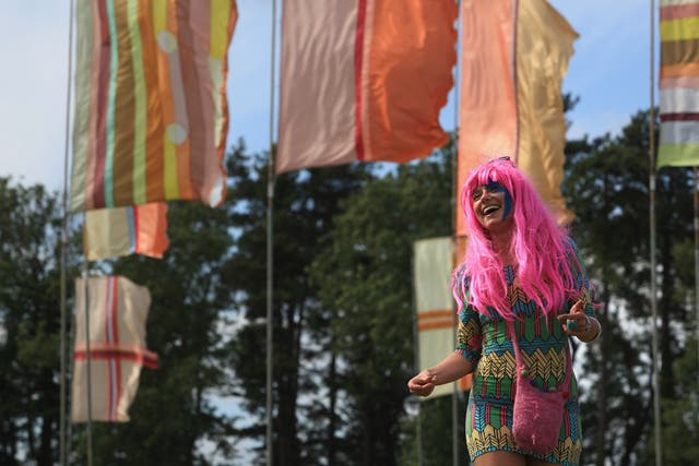 A festival goer enjoys the atmosphere at Womad festival in Wiltshire