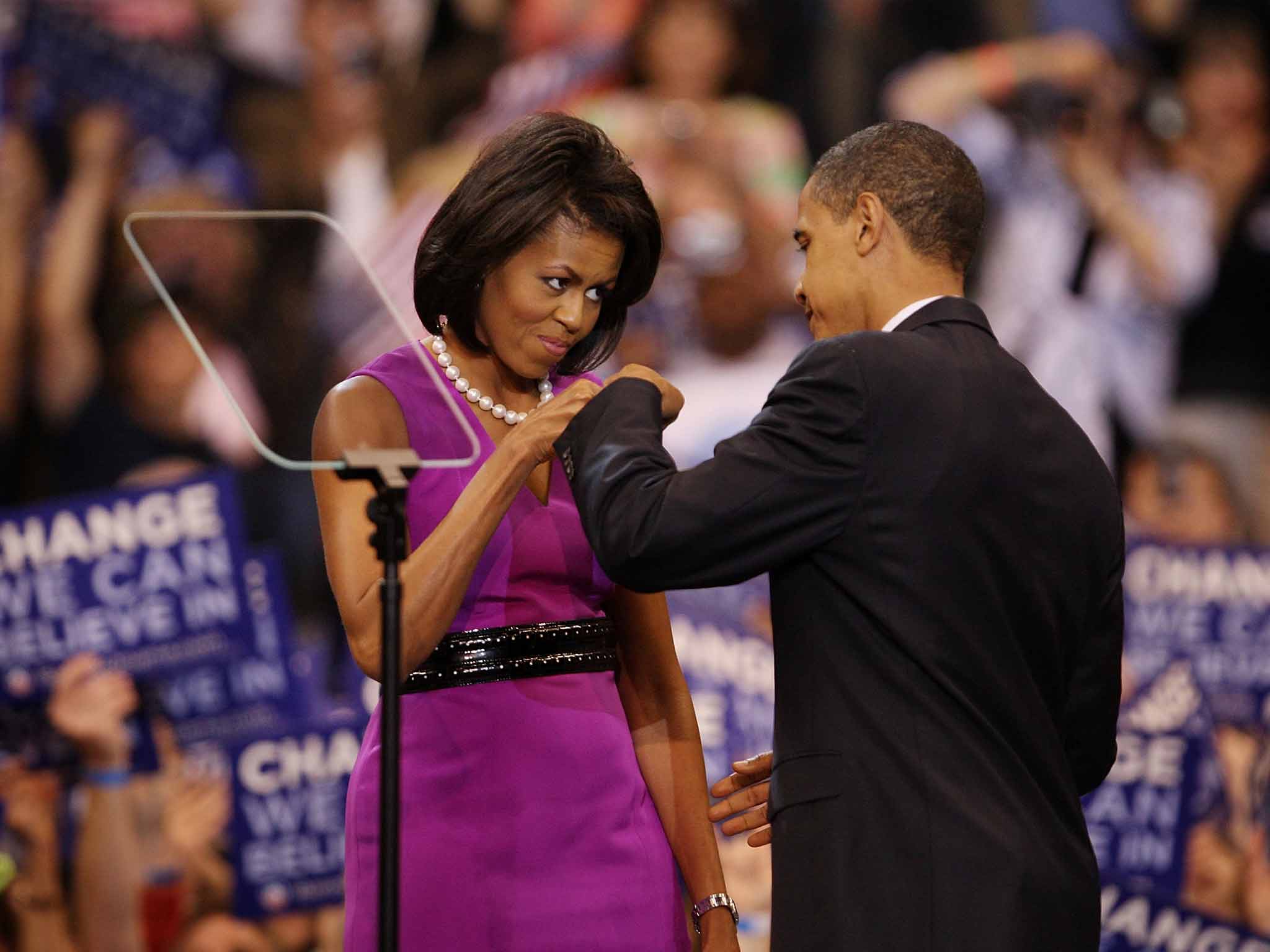 Shake down: Michelle and Barack Obama bump knuckles before an election night rally in Minnesota in 2008, the 'Washington Post' called it 'the fist bump heard round the world'