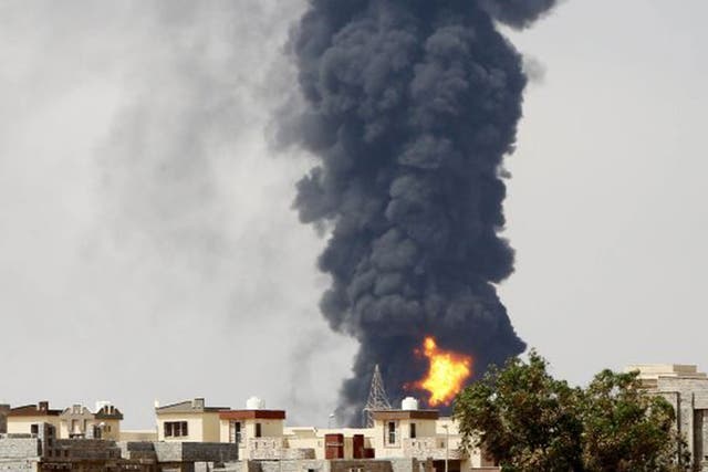 Smoke billows from the oil depot following clashes near Tripoli airport