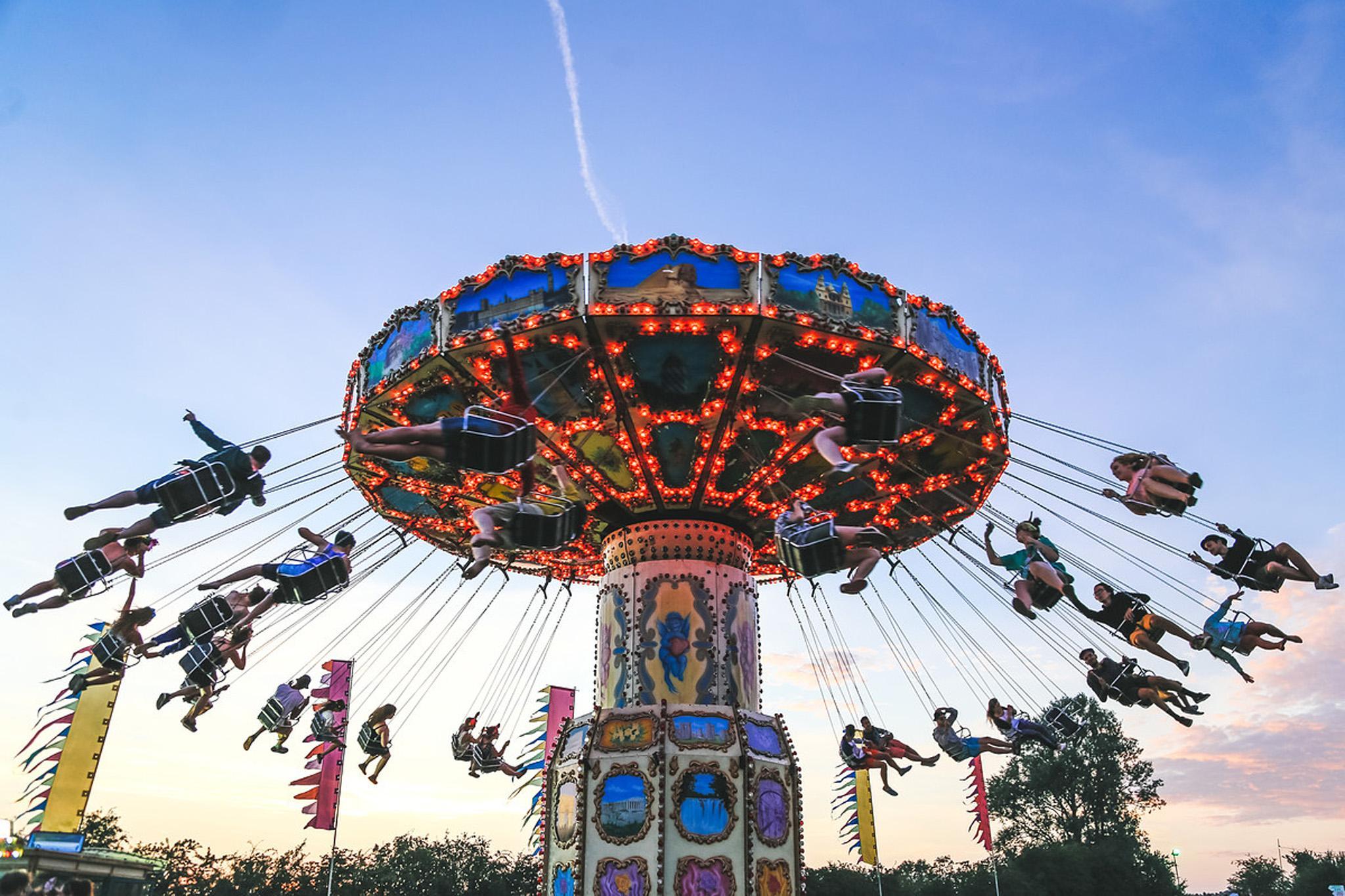 Festival-goers enjoy a fairground ride at Secret Garden Party 2014