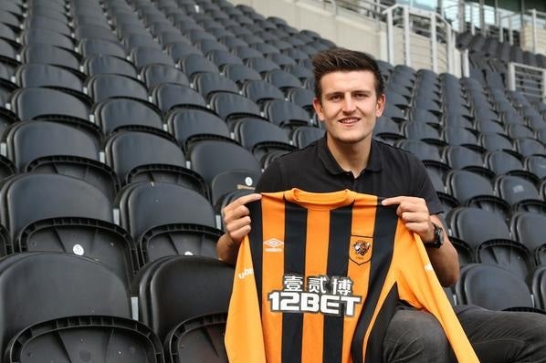 Harry Maguire shows off his Hull City shirt at the KC Stadium after completing a £2.5m switch