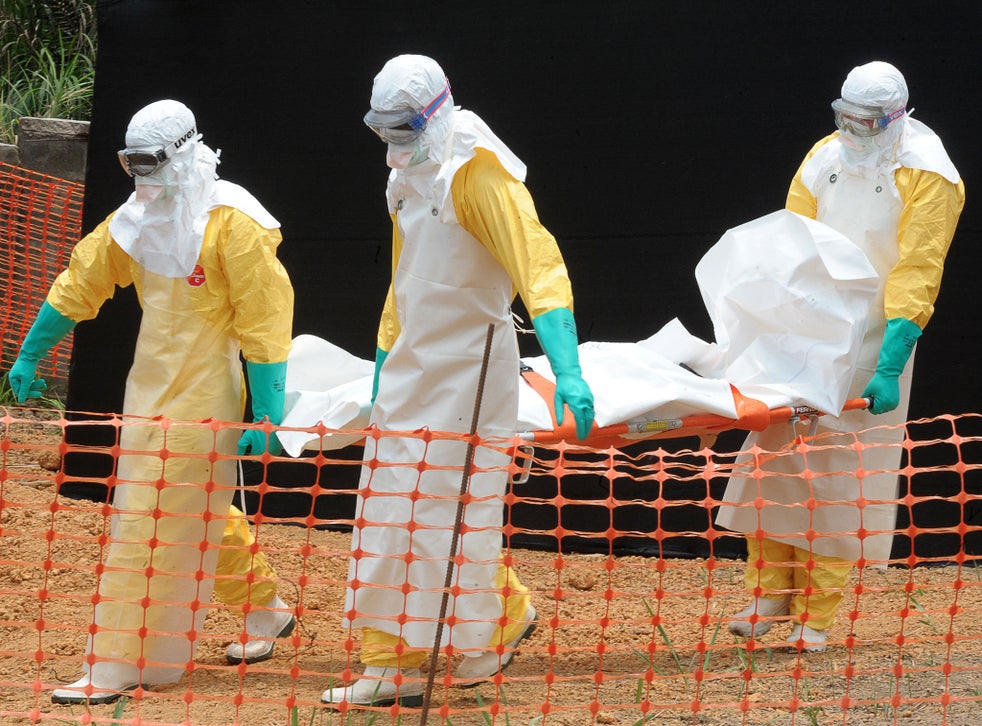 Staff of 'Médecins sans frontières' carry the body of a person killed by viral haemorrhagic fever, at a center for victims of the Ebola virus in Guekedou, on April 1, 2014. 