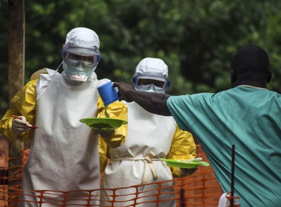 Medical staff working with Medecins sans Frontieres prepare to bring food to patients kept in an isolation area at the MSF Ebola treatment centre in Kailahun July 20, 2014.