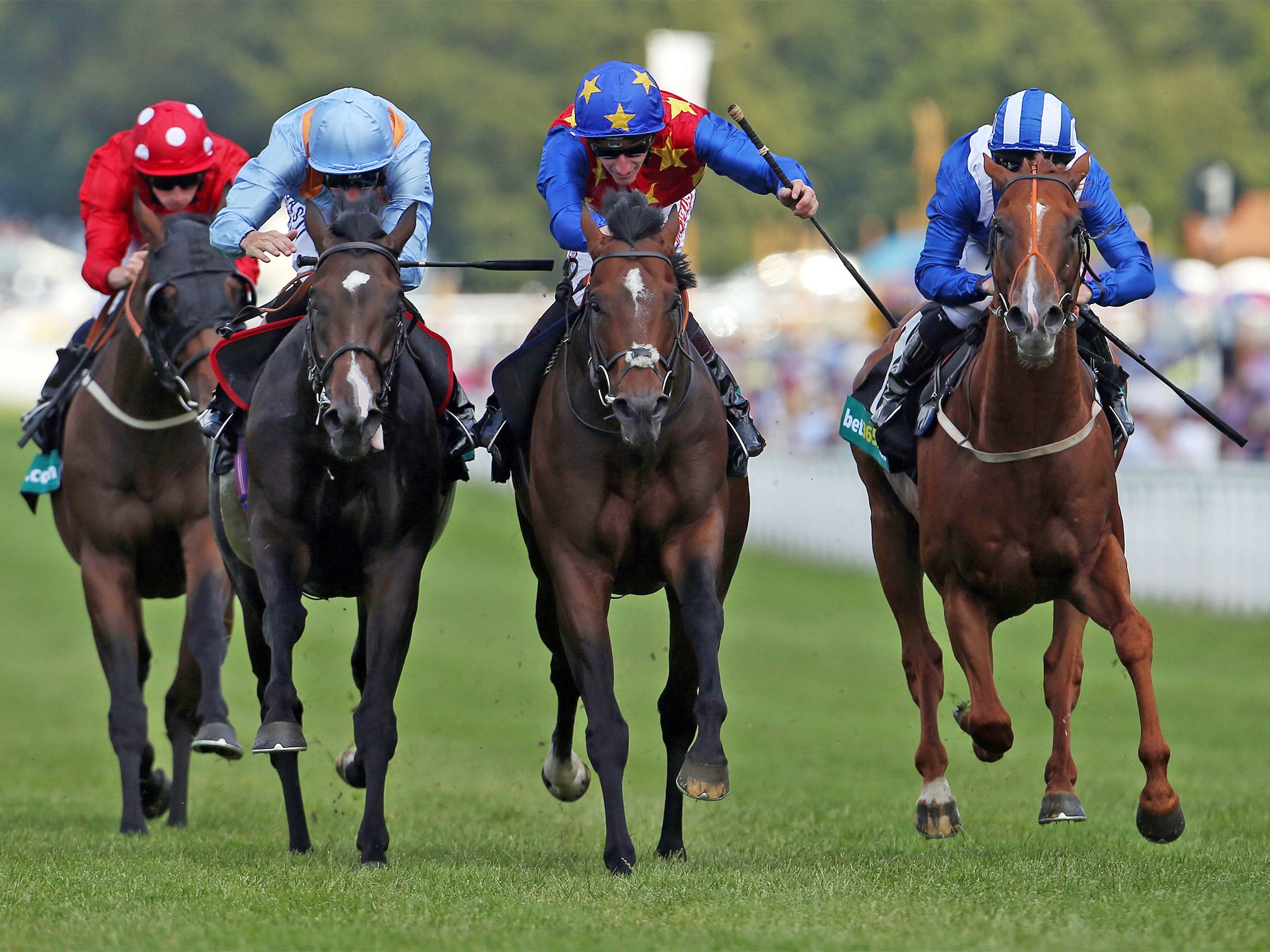 Es Que Love (centre), ridden by Adam Kirby, wins the Lennox Stakes at Goodwood