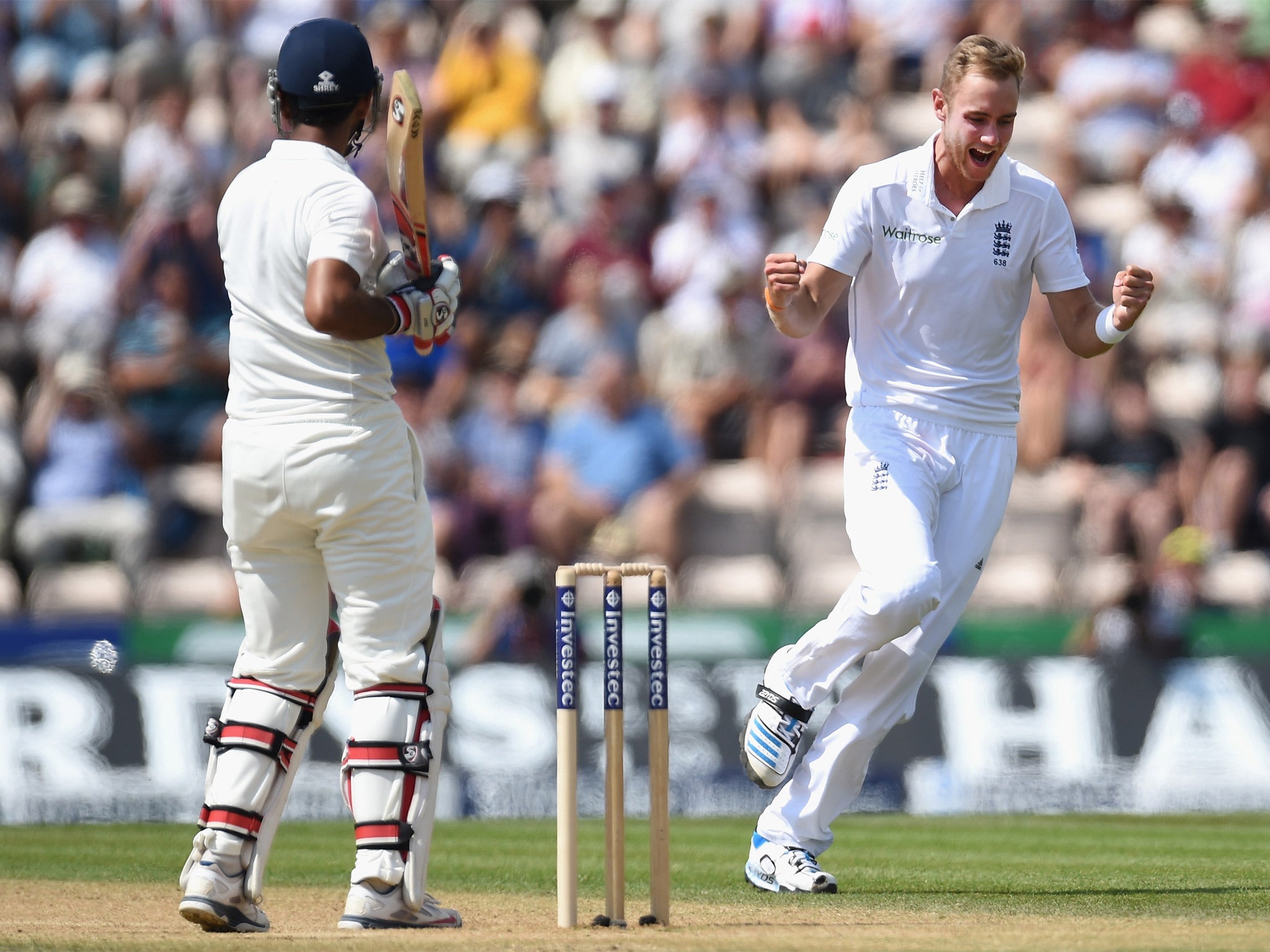 Stuart Broad celebrates after having India batsman Cheteshwar Pujara caught by Jos Buttler to claim his 250th test wicket