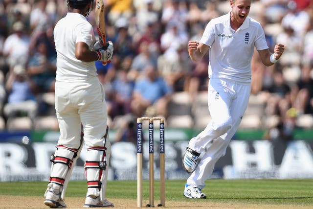 Stuart Broad celebrates after having India batsman Cheteshwar Pujara caught by Jos Buttler to claim his 250th test wicket 