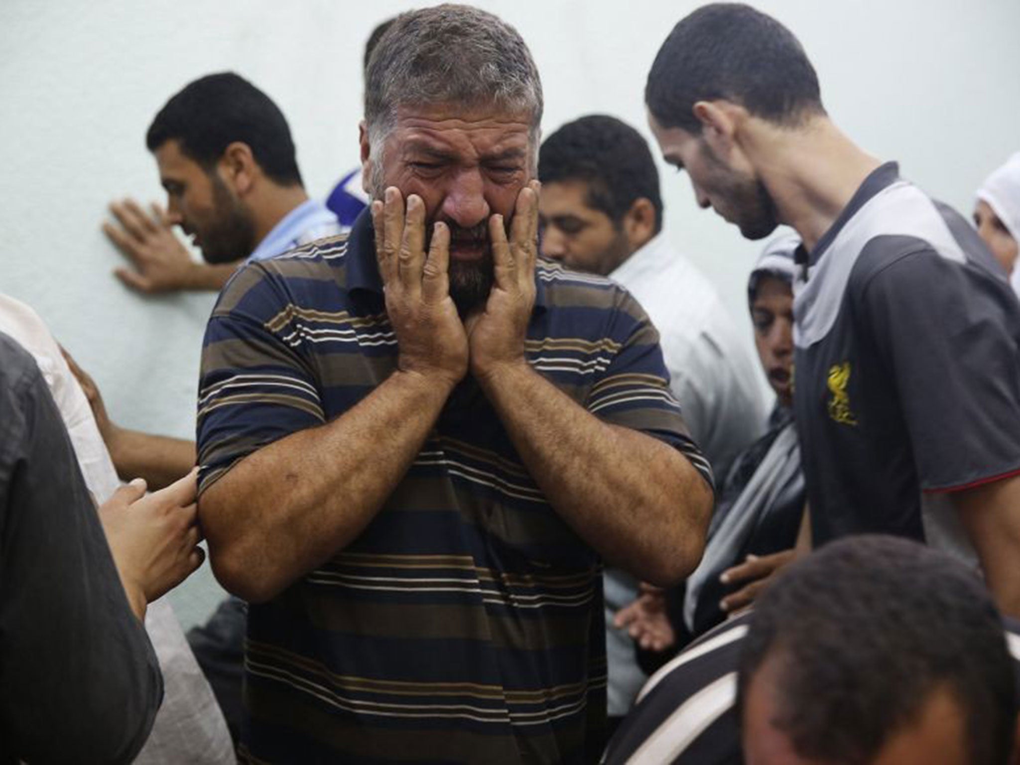 A Palestinian man mourns a relative who medics said died in Israeli shelling during the Israeli ground offensive