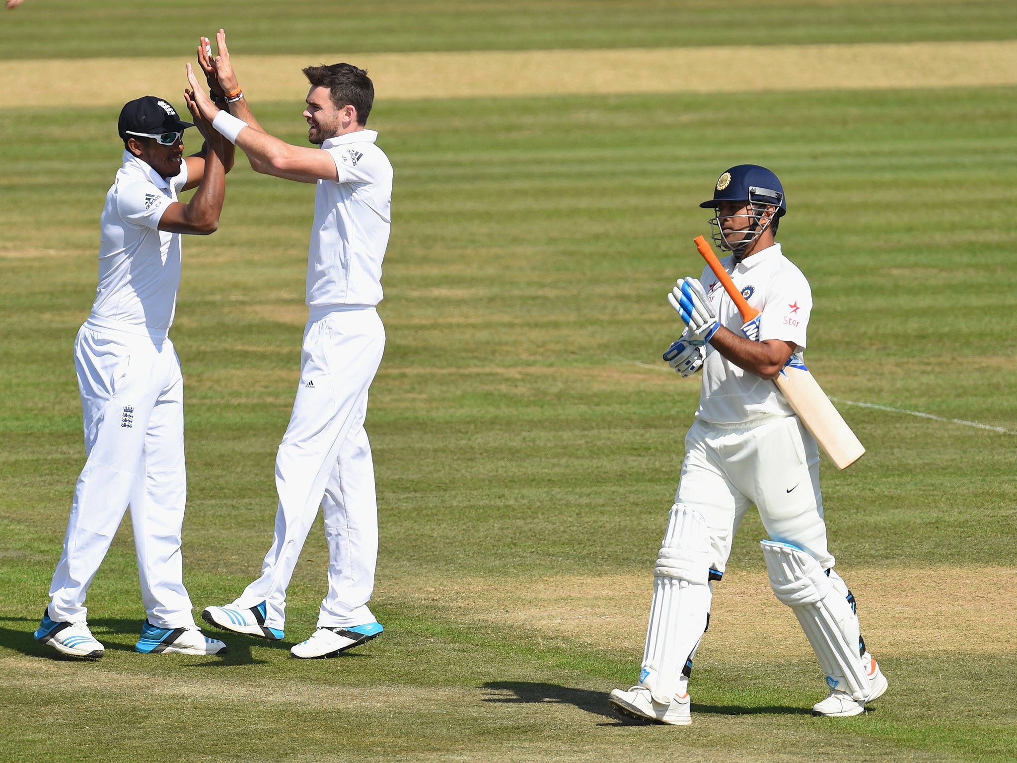 James Anderson is congratulated by Chris Jordan after taking the wicket of M.S Dhoni (Getty)