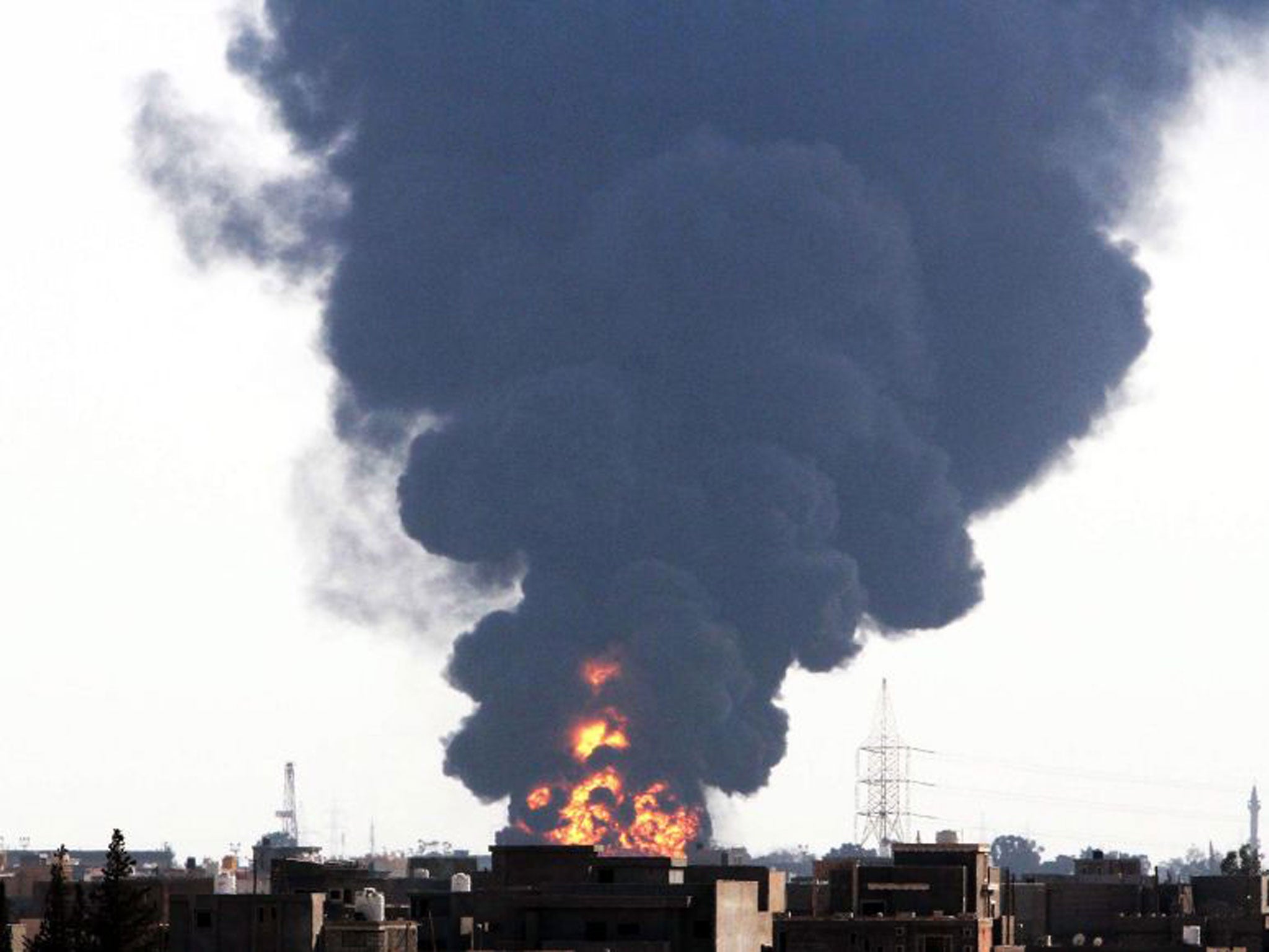 Black smoke billows from fuel storage depot near Tripoli International Airport on Monday