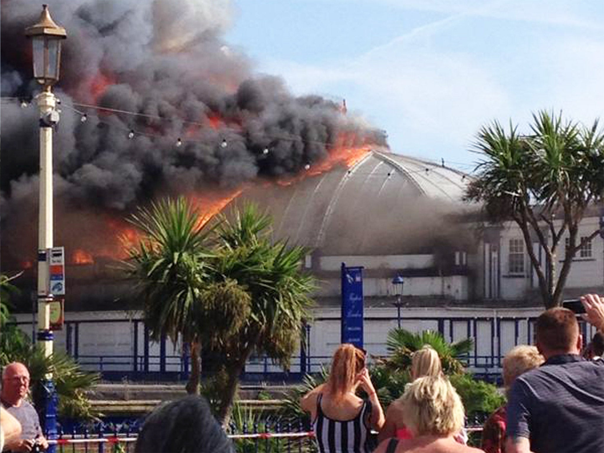 Onlookers take photos as Eastbourne Pier is ablaze