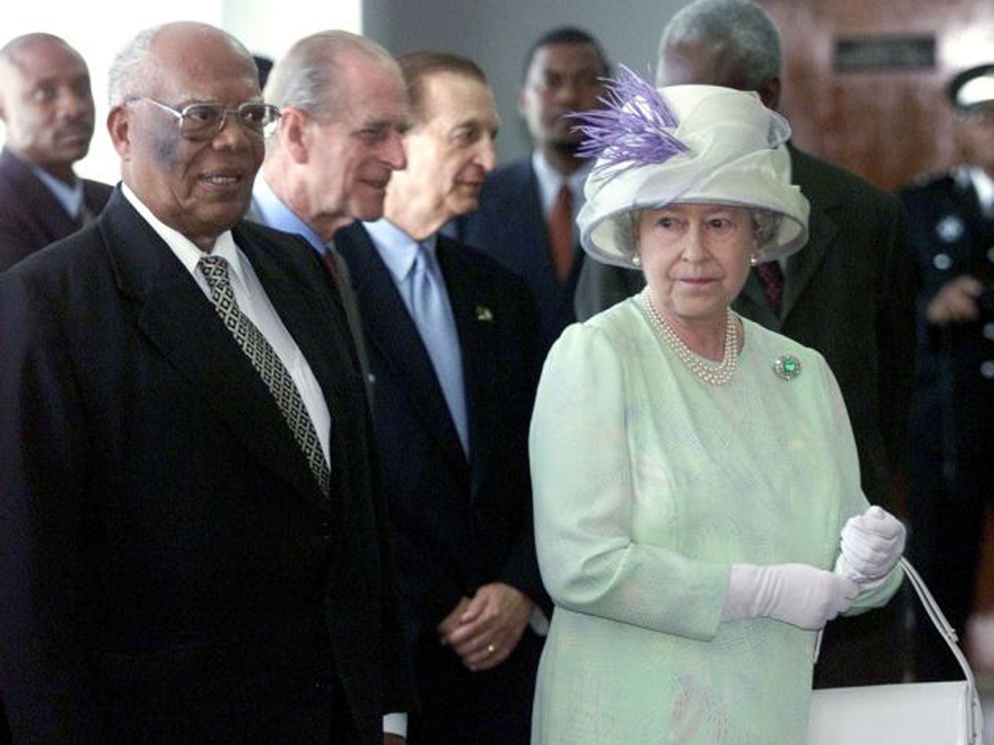 Sir Howard Cooke with the Queen in Kingston, Jamaica, in 2002