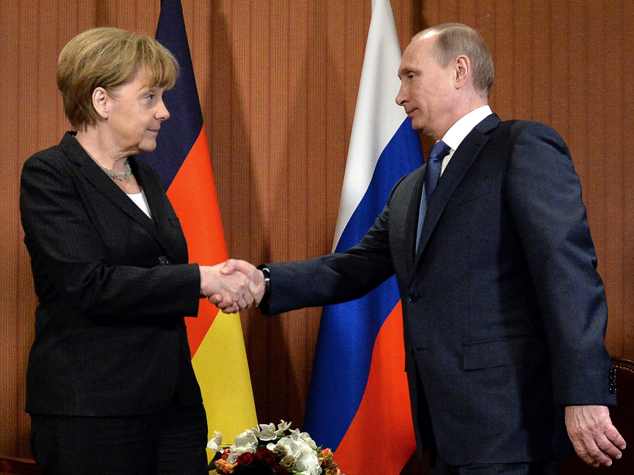 Russian President Vladimir Putin shakes hand with German chancellor Angela Merkel, during a meeting last month