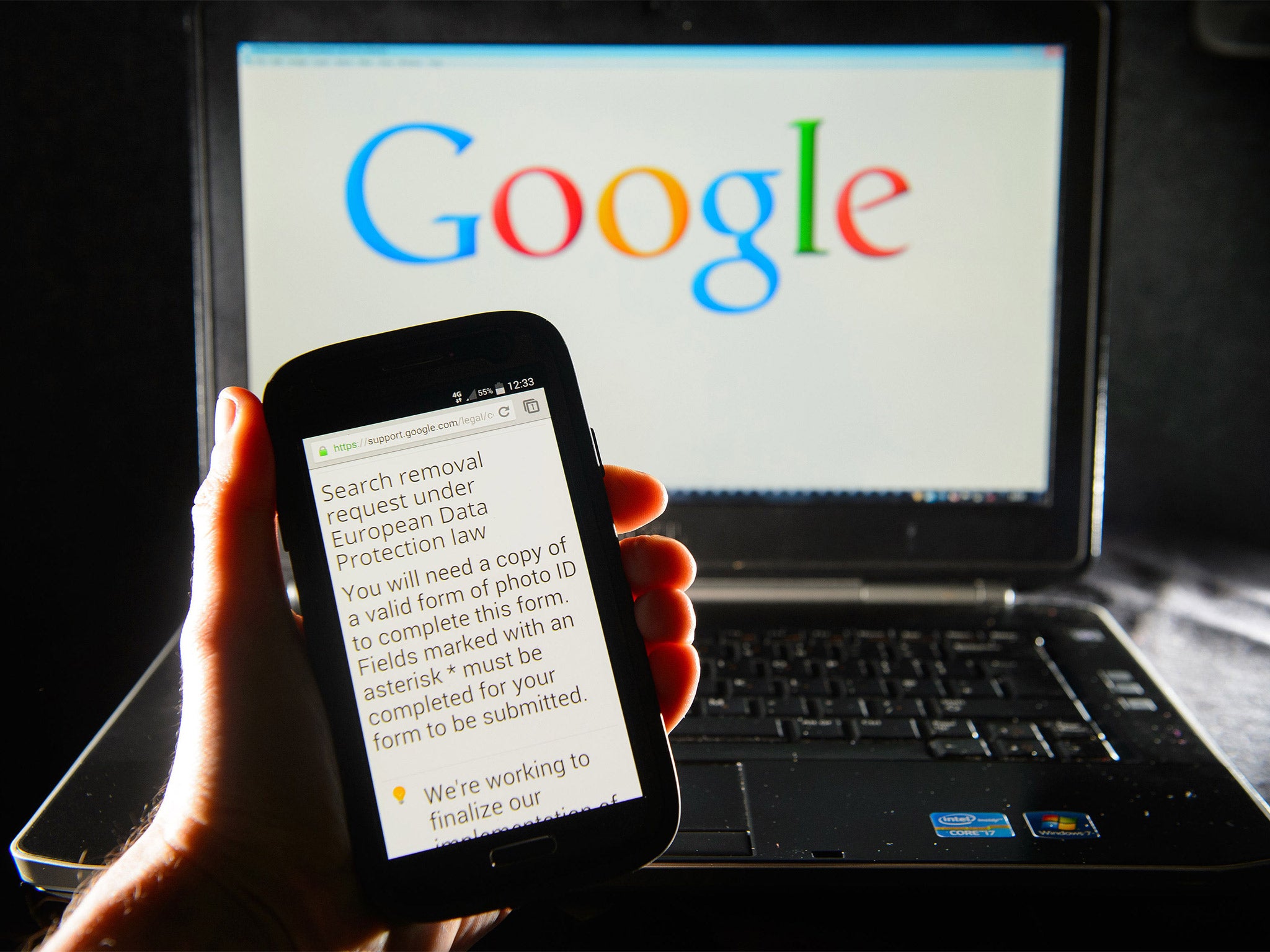 A Google search removal request displayed on the screen of a smart phone