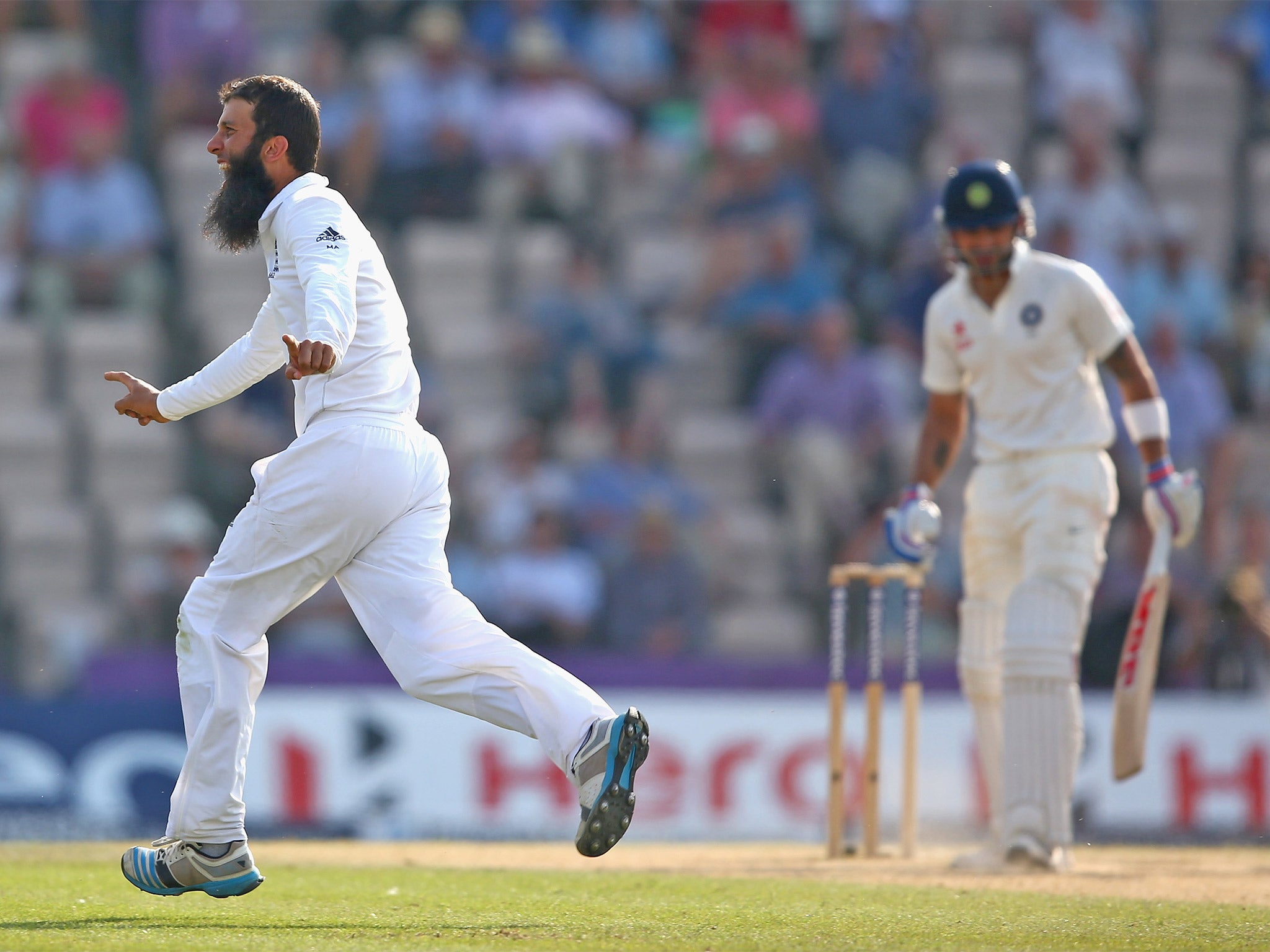 Moeen Ali of England celebrates capturing the wicket of Virat Kohli