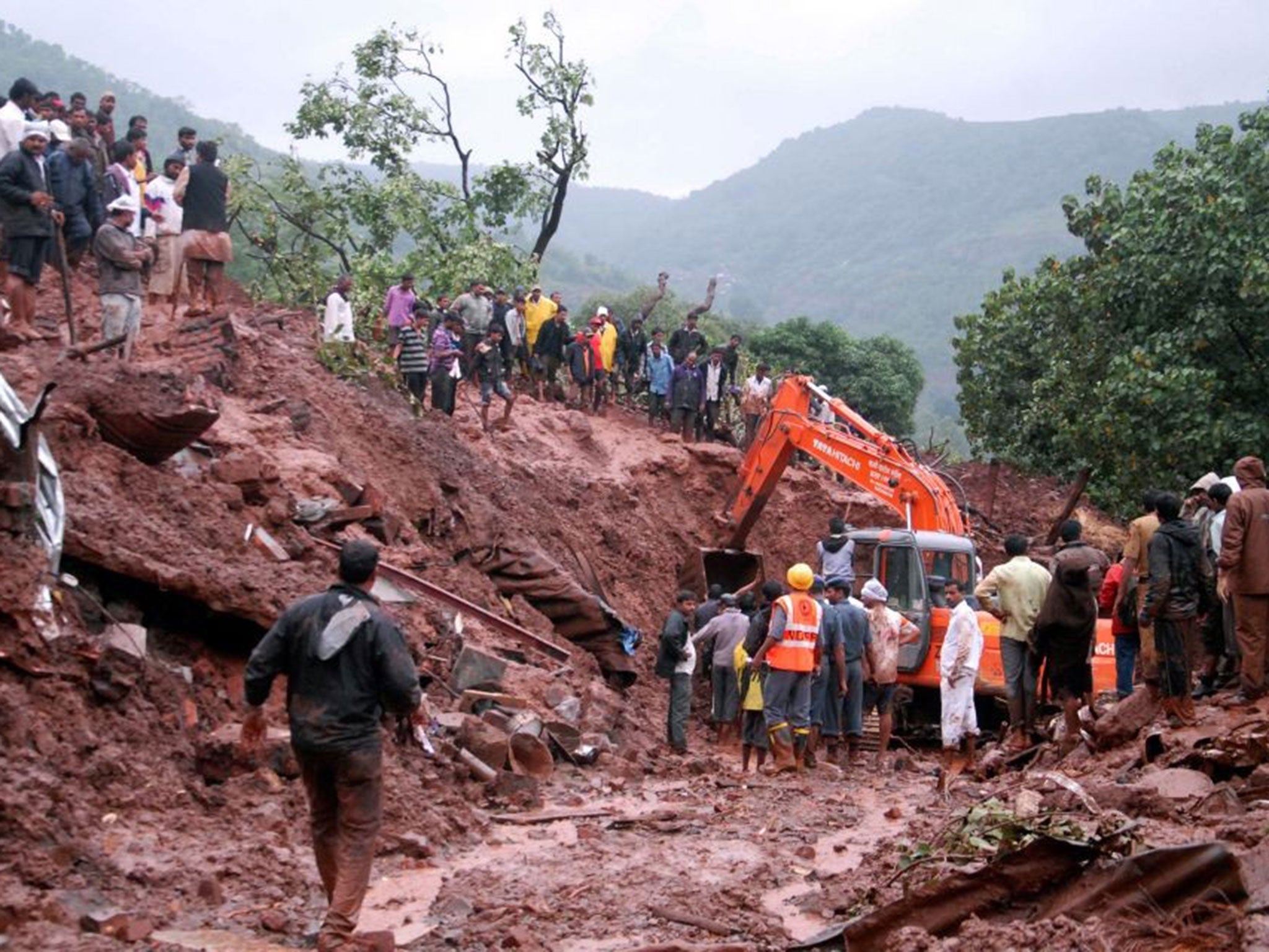 Rescuers work at the site of a landslide in Malin village, in the western Indian state of Maharashtra (AP)