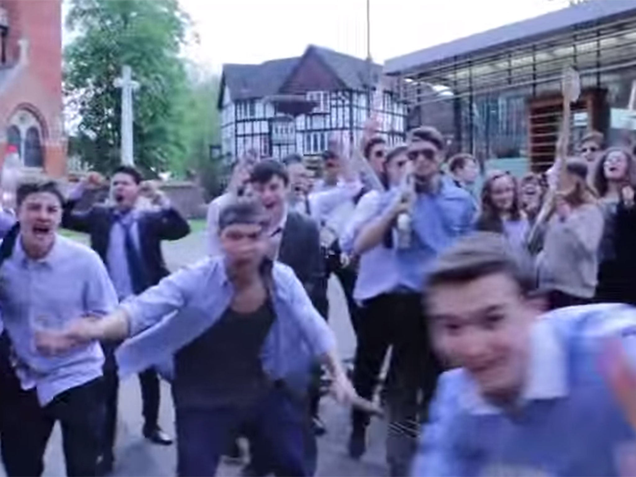 A scene from the video shows students mock rioting