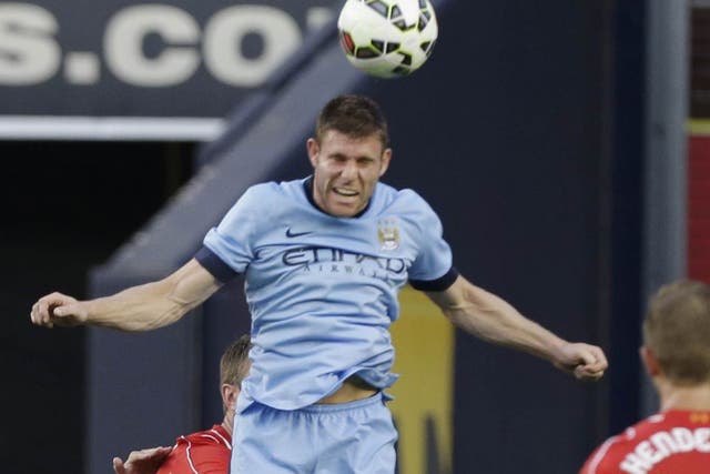 Midfielder James Milner uses his head for Manchester
City in their pre-season match with Liverpool in New York