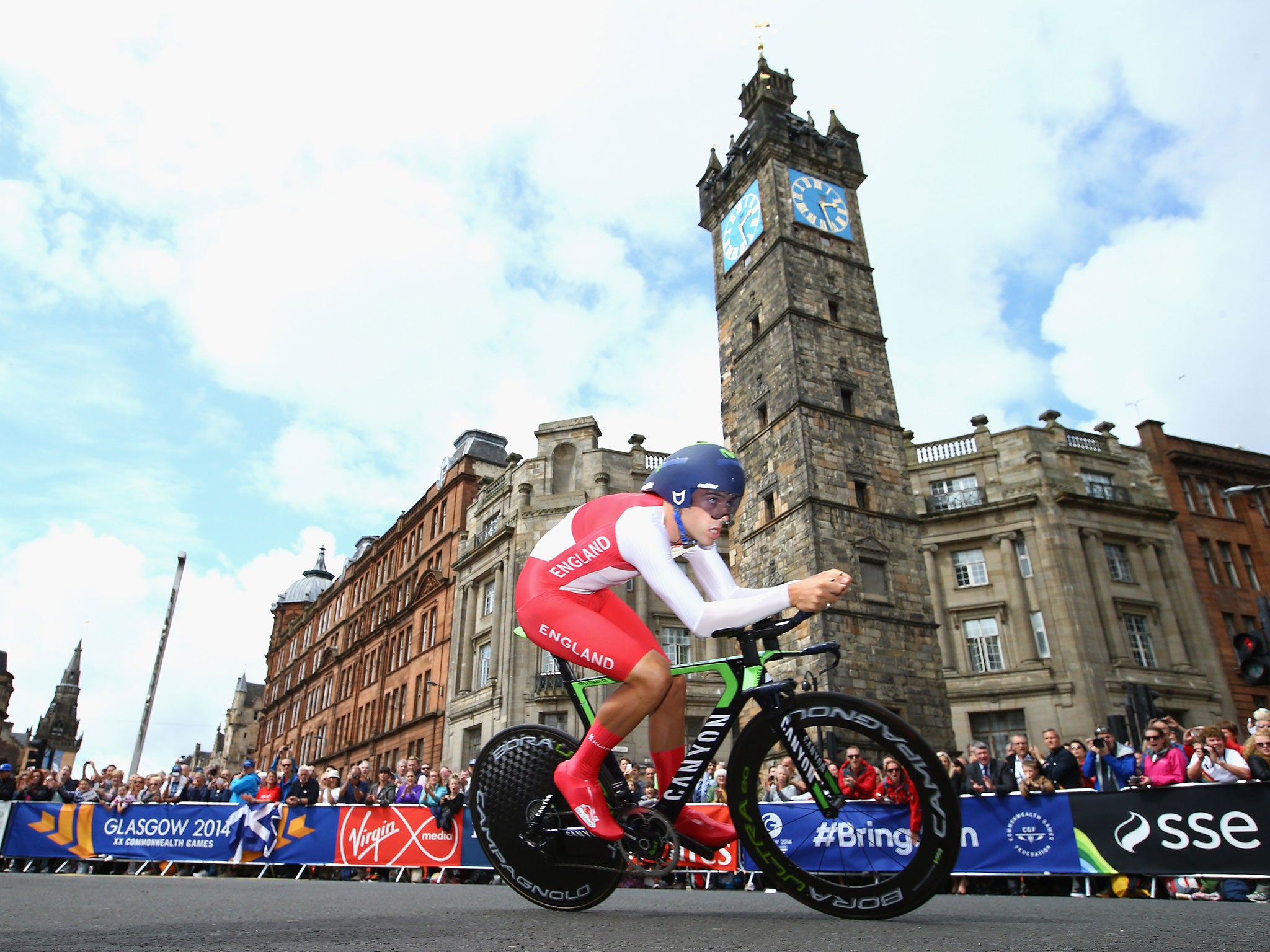 Alex Dowsett of England goes past the Tolbooth in Glasgow on his way to victory in the men’s individual time trial yesterday