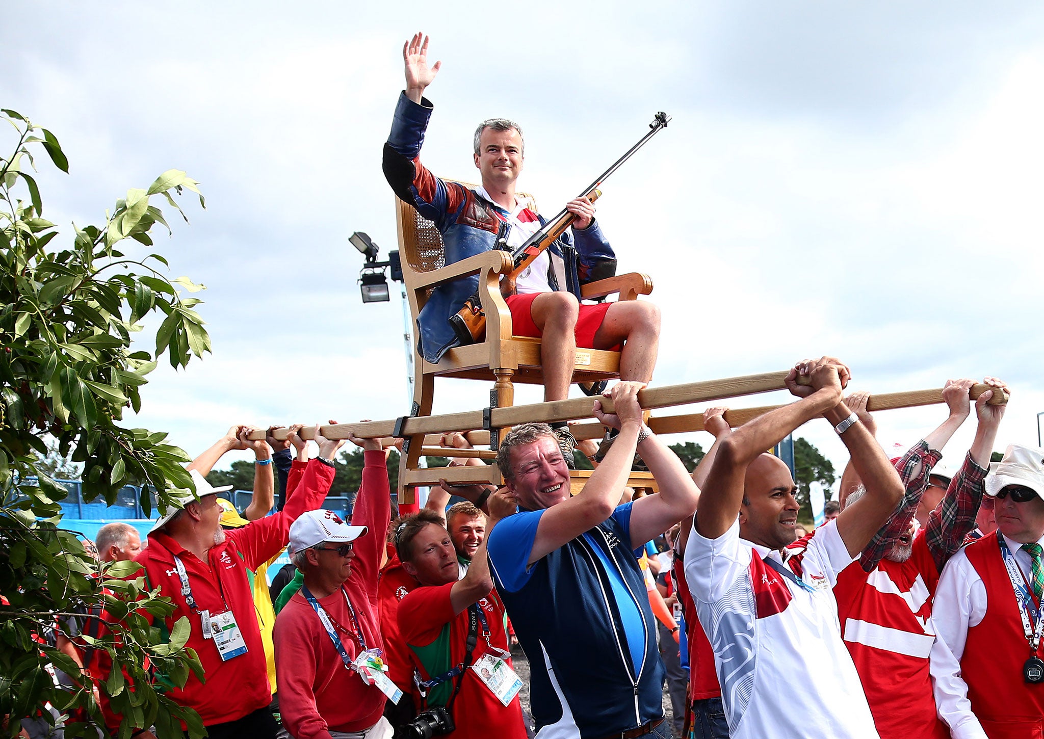 A bit shot? England's David Luckman is carried in a sedan chair after winning gold for his shooting