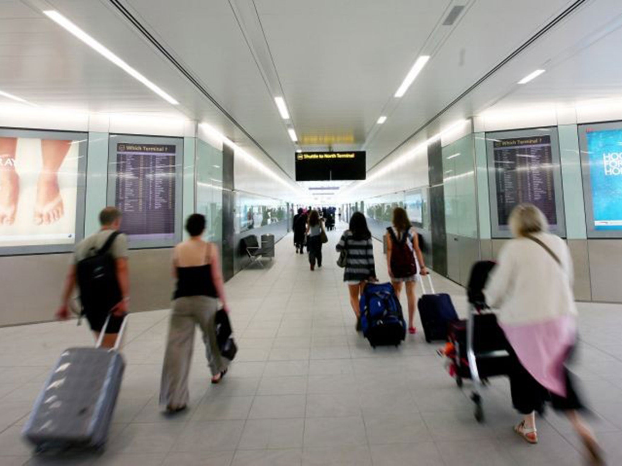 Air passengers walking through Gatwick Airport as the airport is bringing in its own staff to help with the luggage crisis amid fears there could be further travel chaos this weekend.