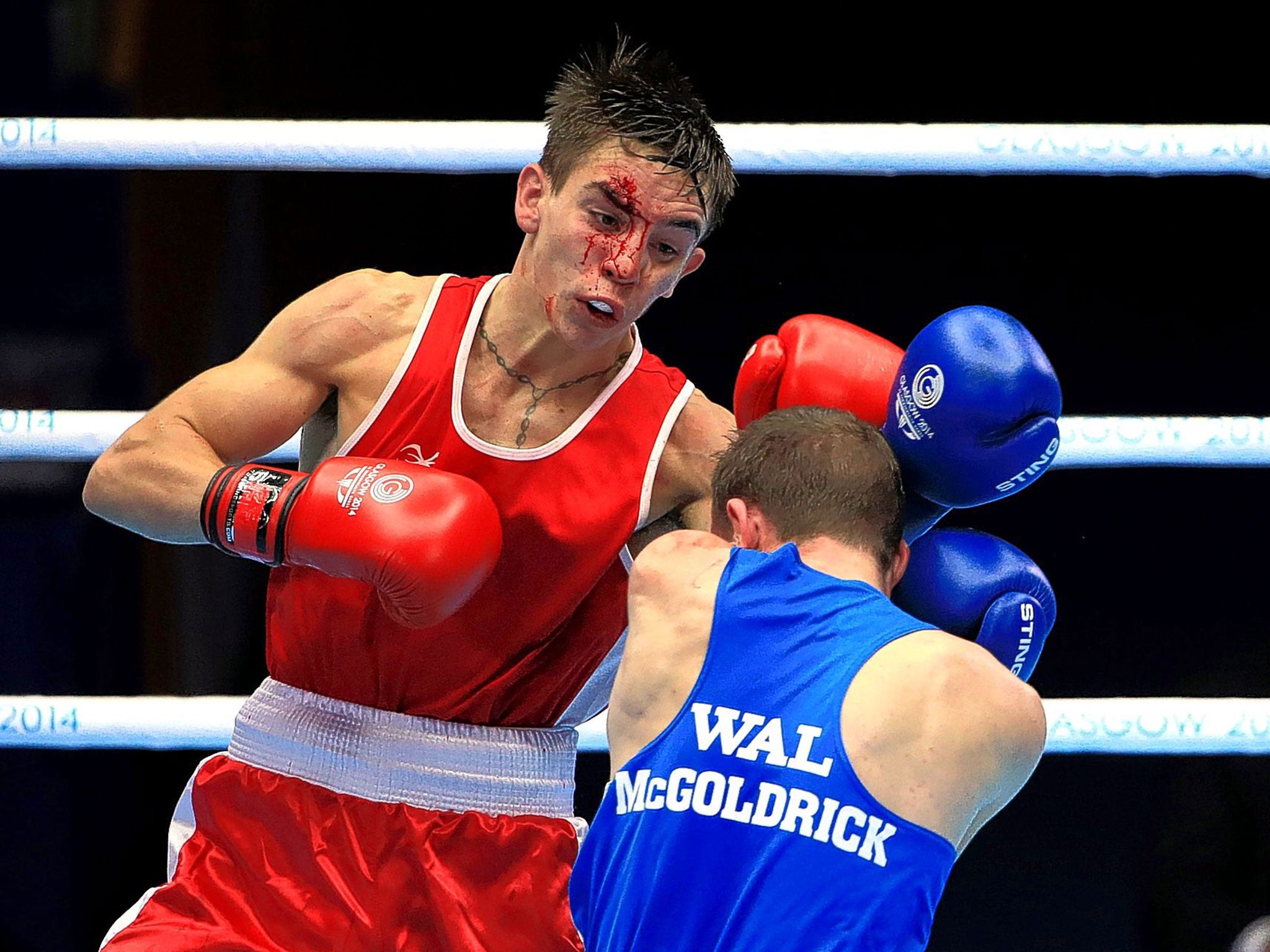 Belfast’s Michael Conlan bravely fights on despite suffering a painful cut to his face against Wales’ Sean McGoldrick in their bantamweight semi-final in Glasgow