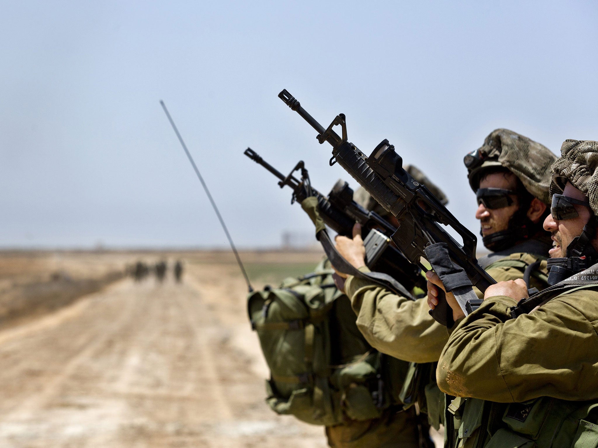Israeli infantry troops check their weapons