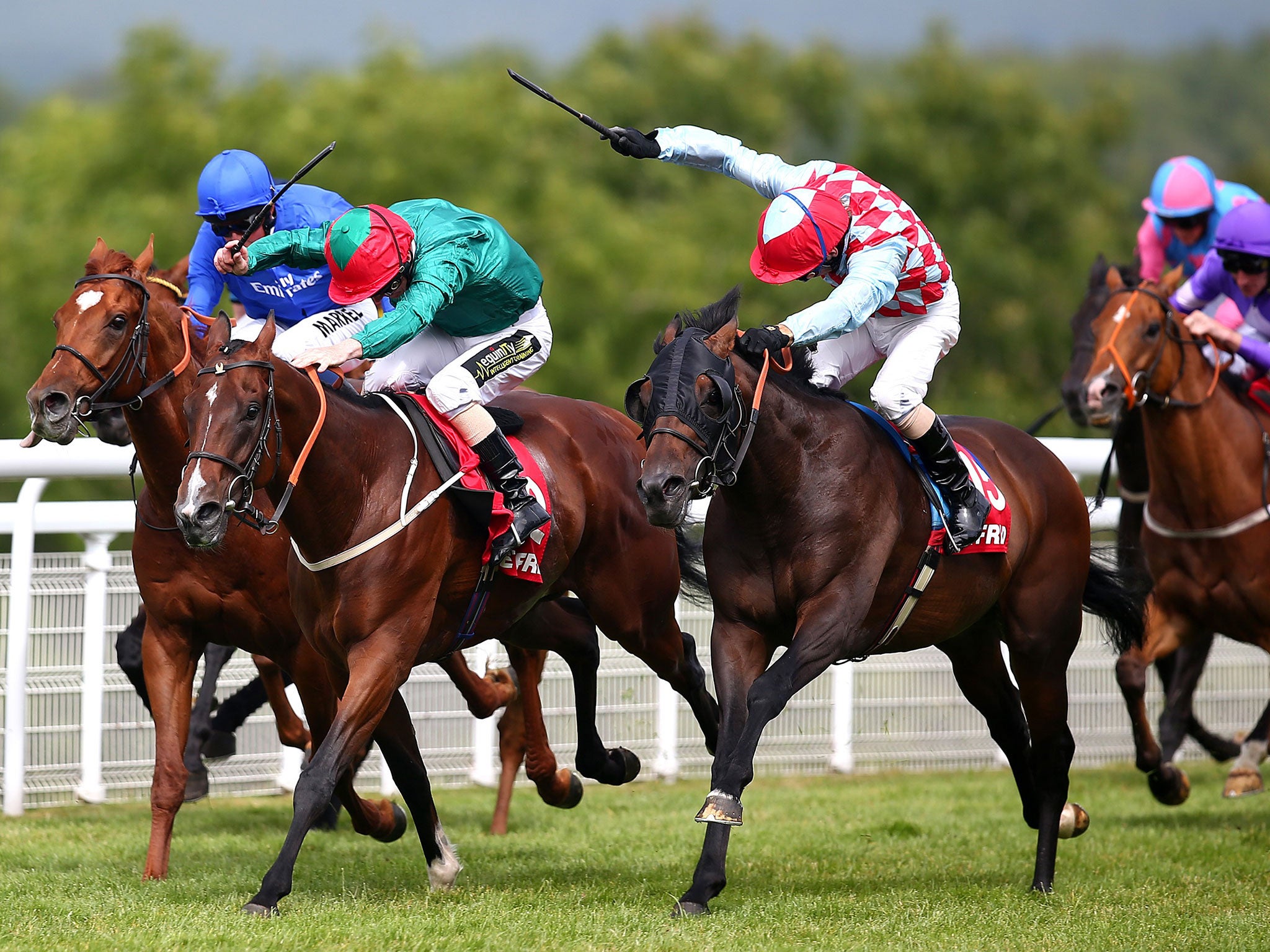 Red Avenger (right) responds to Jimmy Fortune’s urgings to land the Betfred Mile from Heavy Metal at Goodwood yesterday