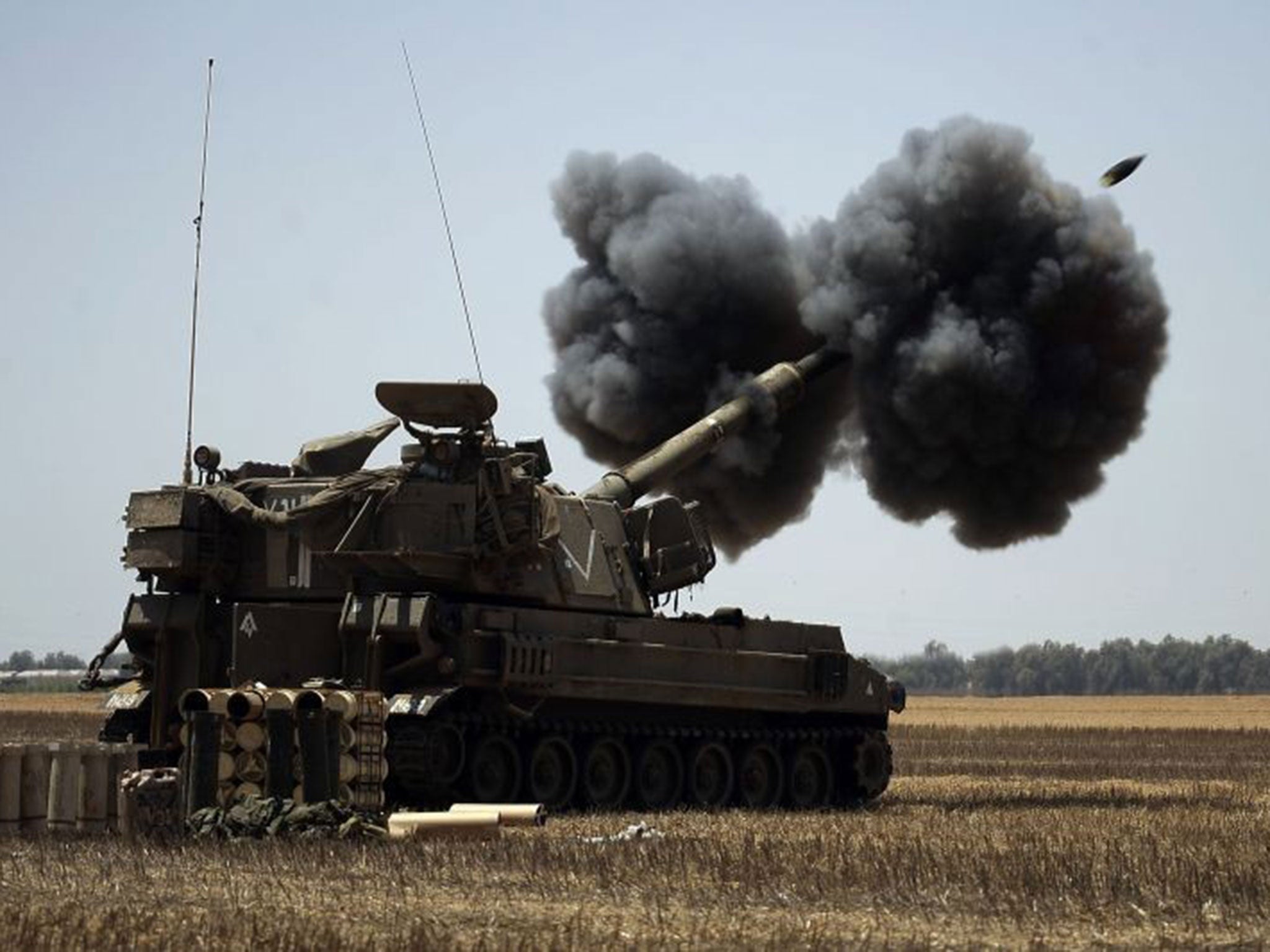 An Israeli canon fires a shell towards targets in the Gaza Strip on 2 August