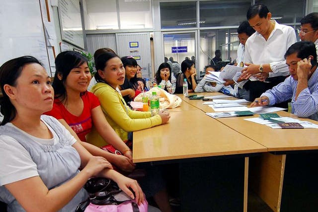 Thai immigration policemen investigate Vietnamese women who were allegedly lured into becoming surrogate mothers 
