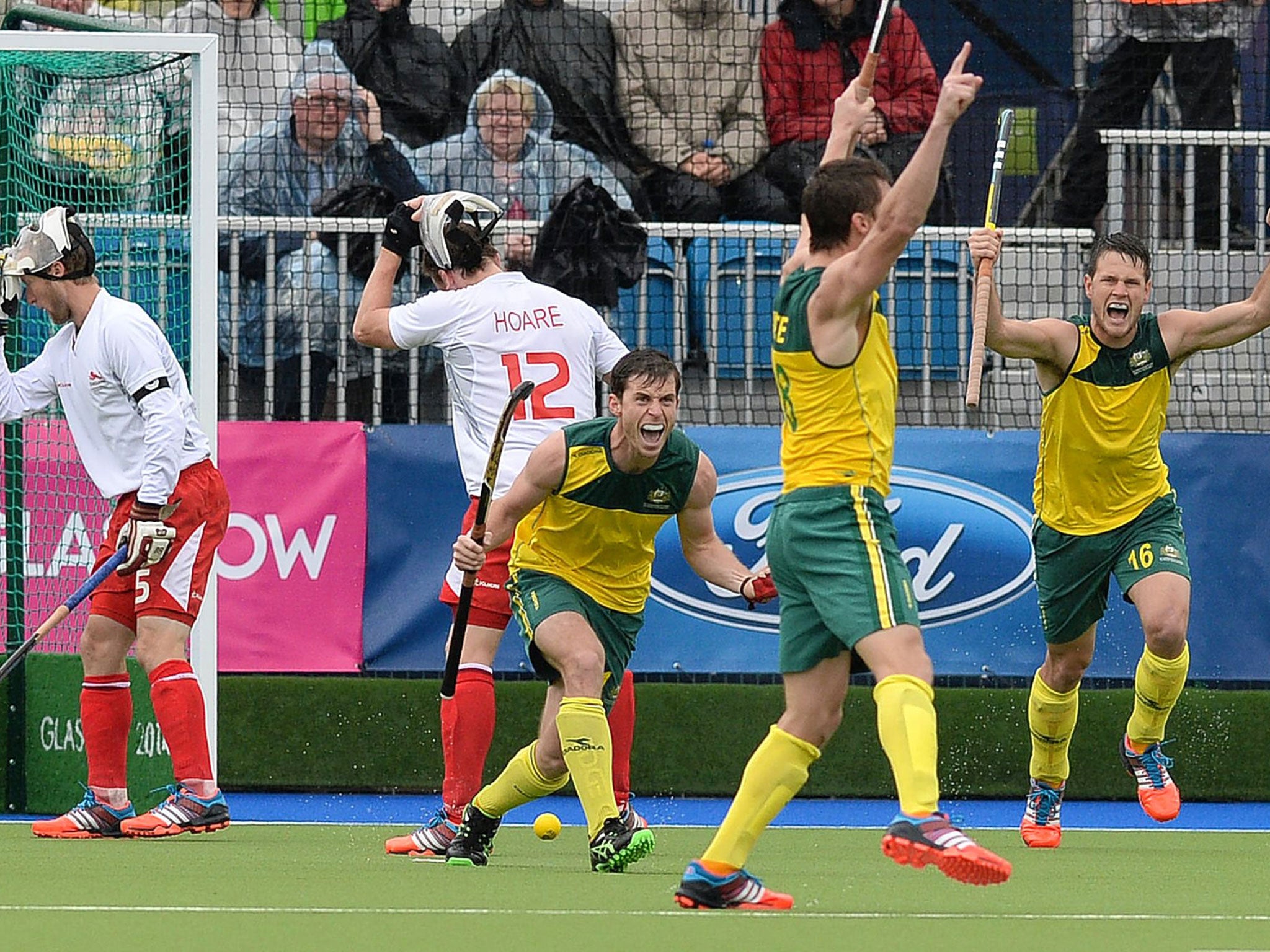 Australia players raise their arms in delight as another goal puts the match beyond England and a place in the final is secured