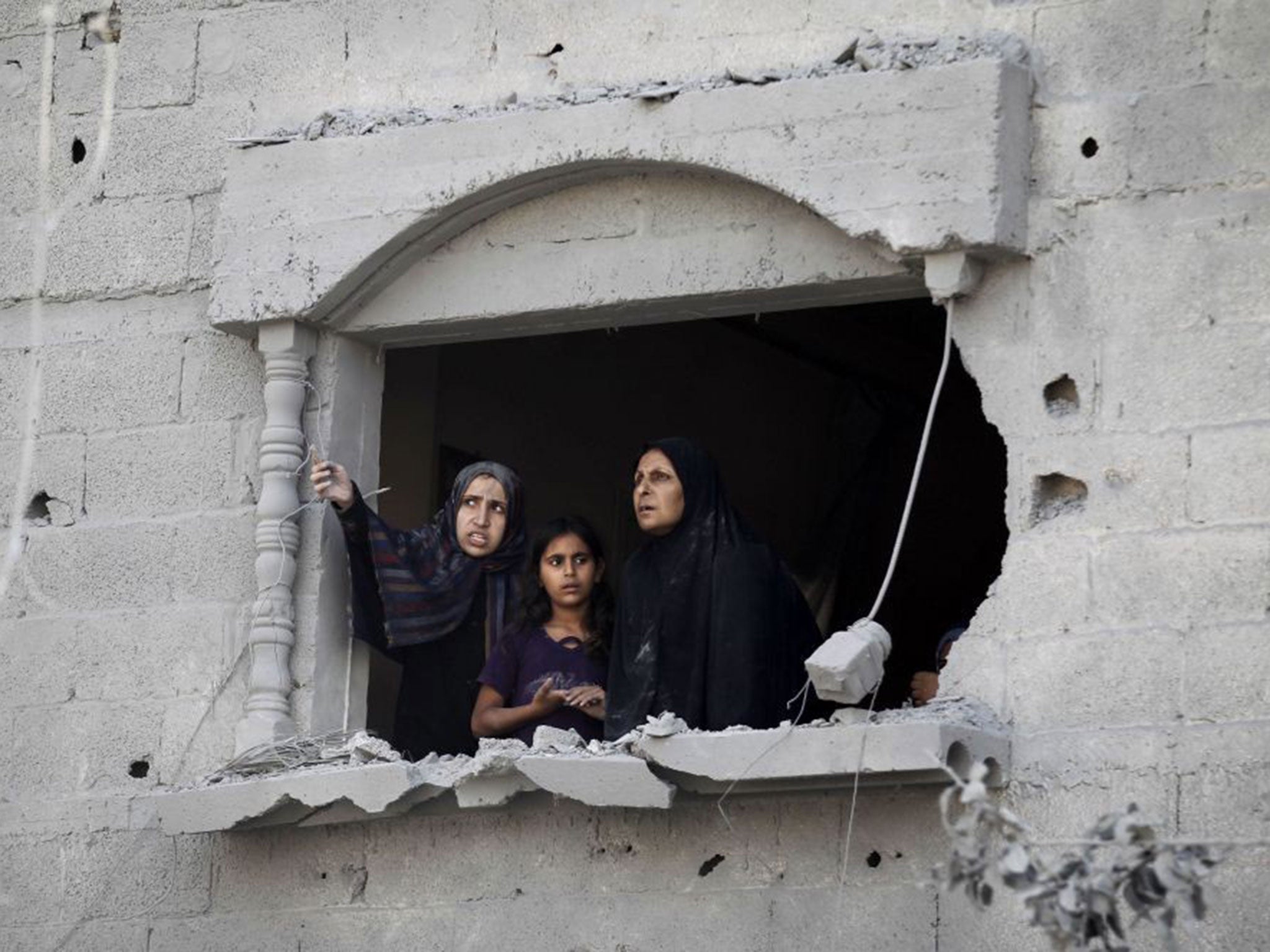 Palestinians observe the wreckage