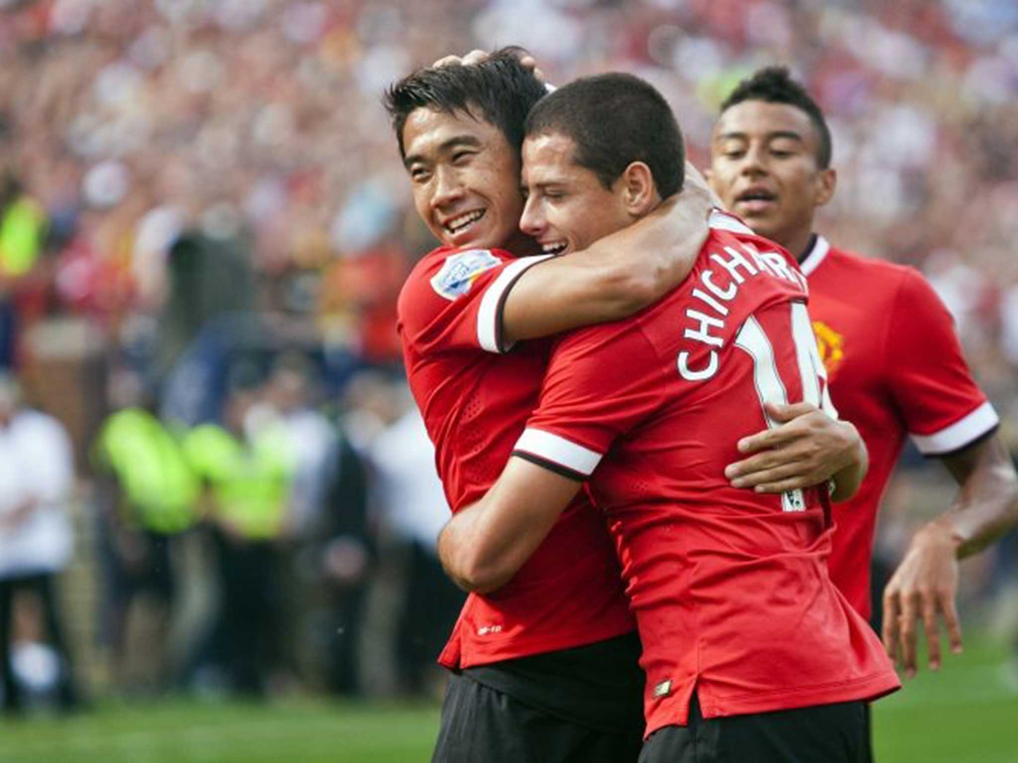 Shinji Kagawa, left, celebrates his assist for a goal from forward Javier Hernandez