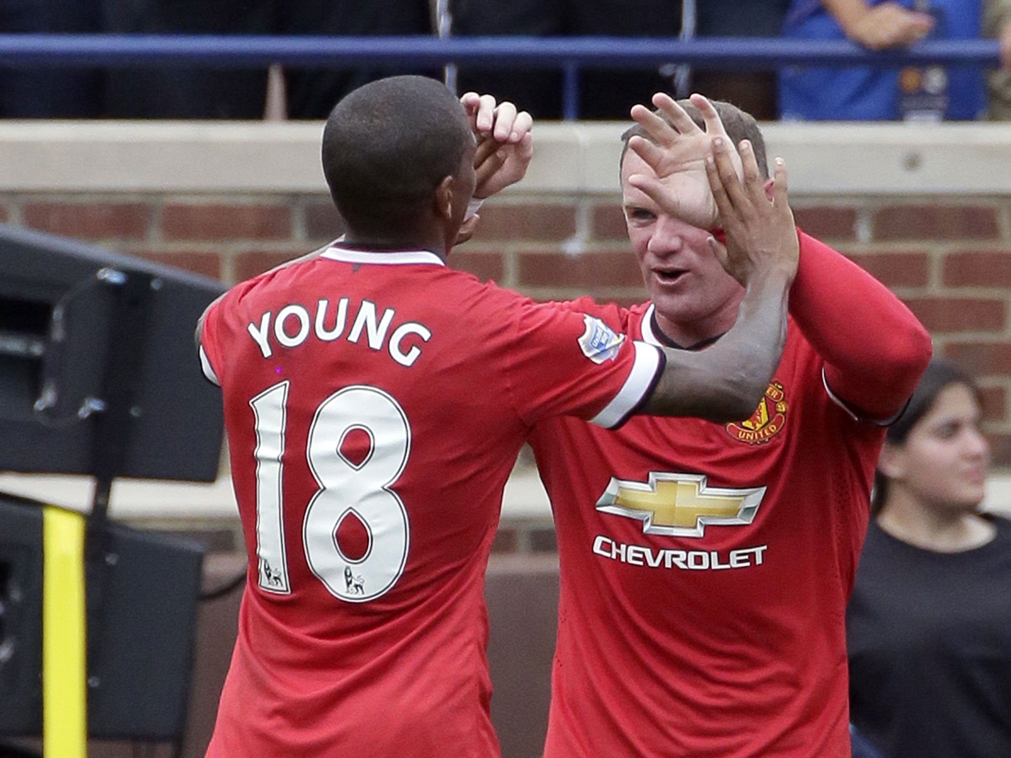 Ashley Young and Wayne Rooney celebrate the opening goal in Ann Arbor