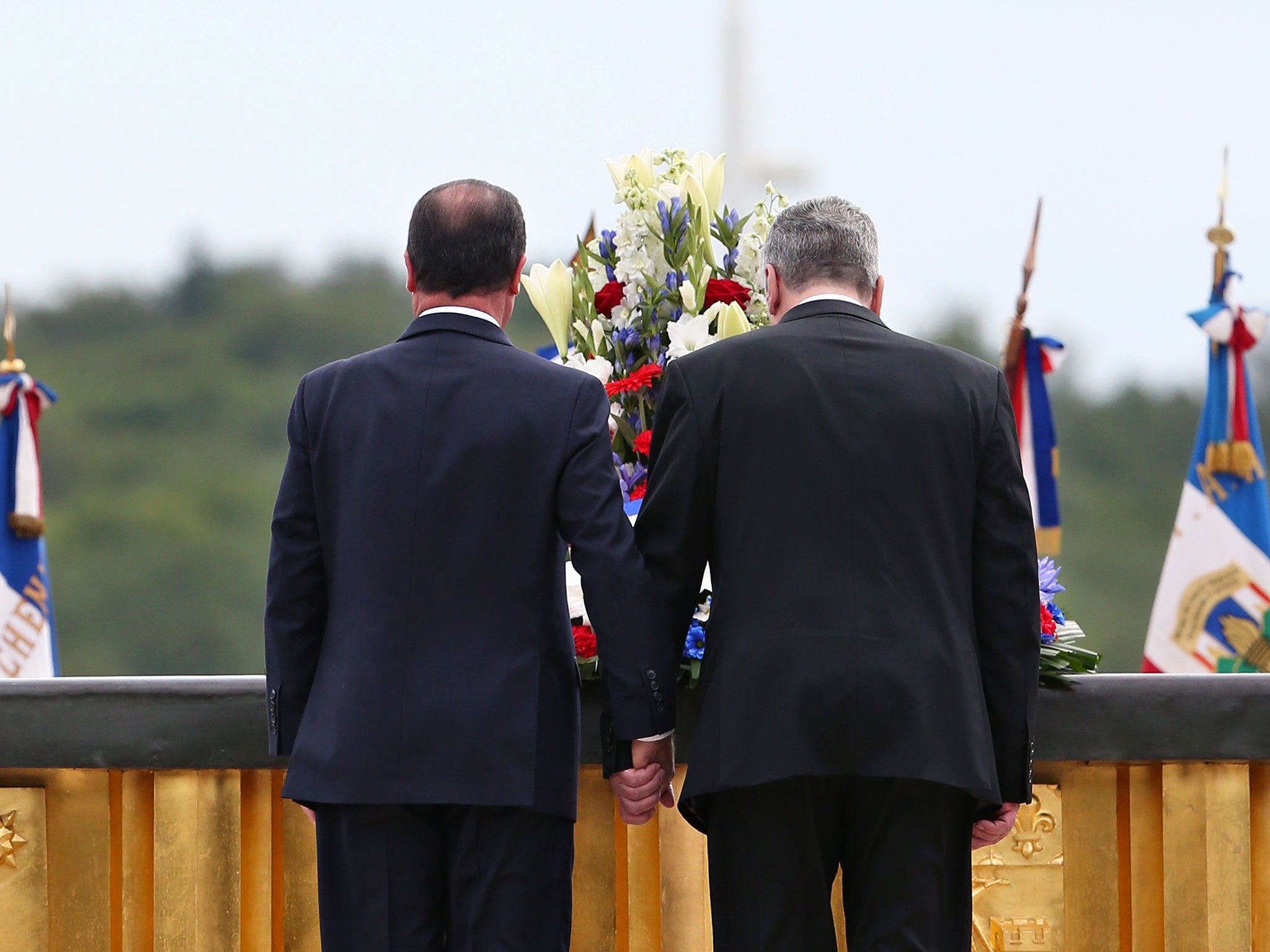 France’s President François Hollande, left, and German President Joachim Gauck pay their respects at the National Monument in Wattwiller, eastern France