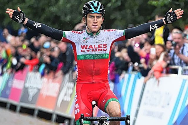Geraint Thomas, of Wales, celebrates winning road race gold