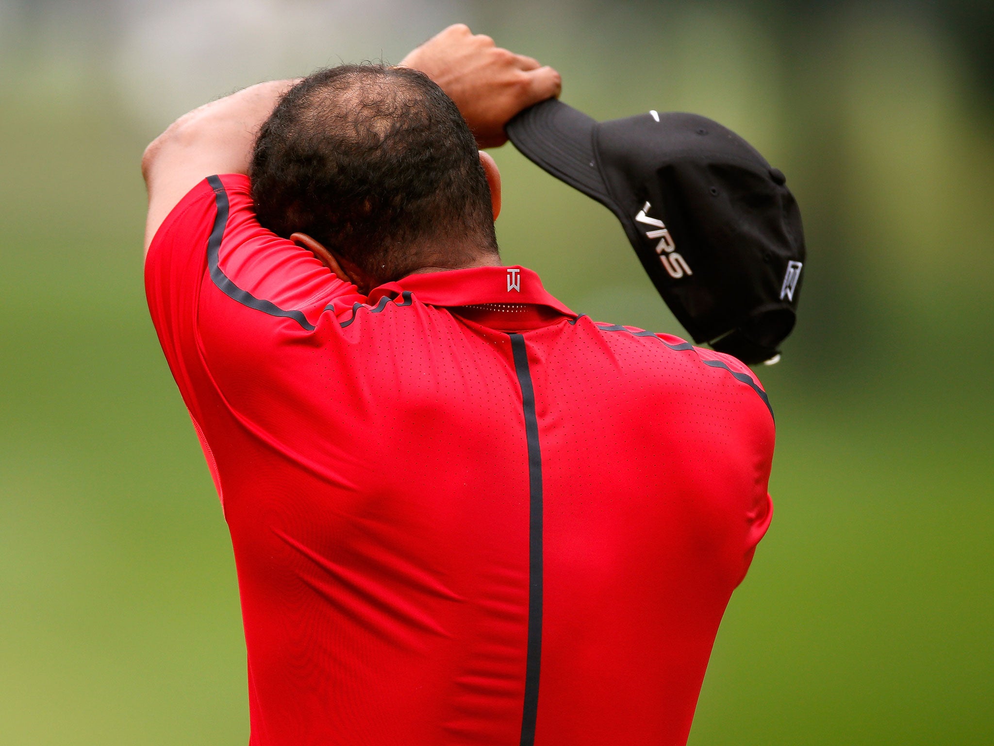 Tiger Woods reacts before withdrawing from the Bridgestone Invitational