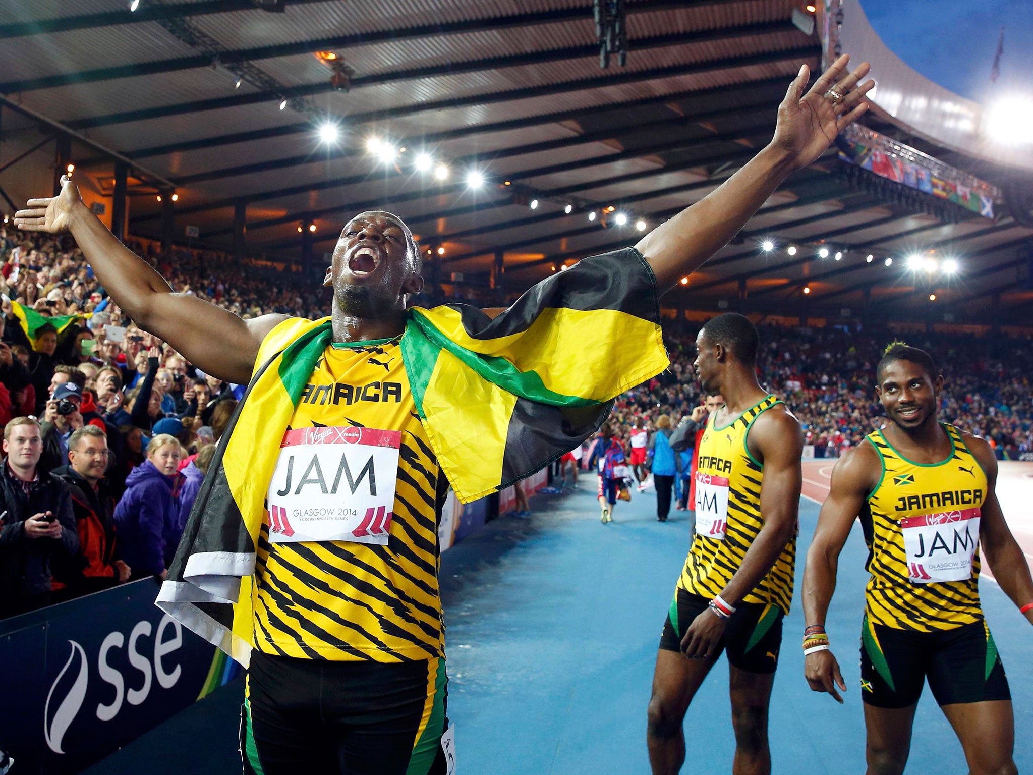 Usain Bolt plays up to the Glasgow crowd after his gold medal in the relay