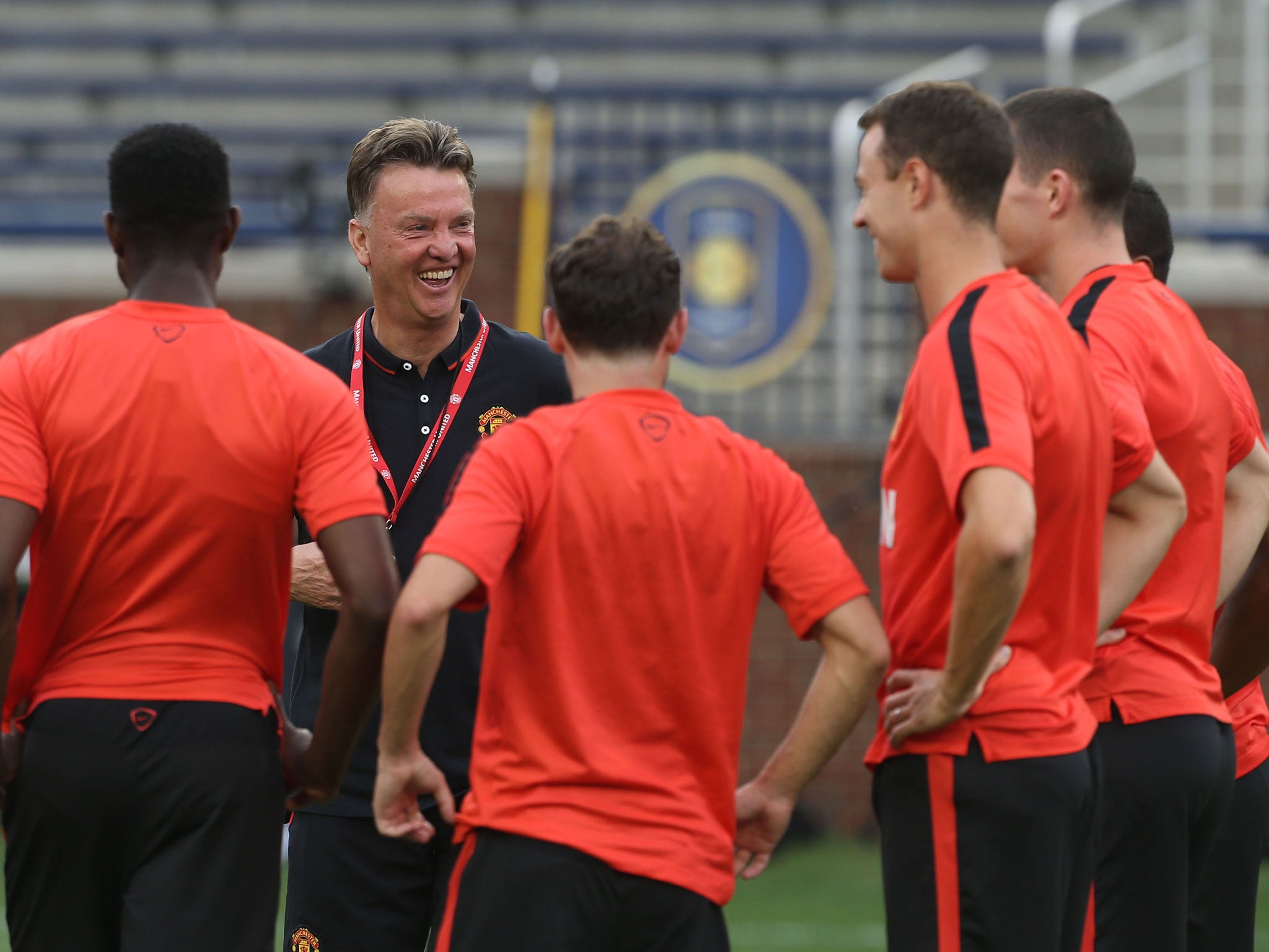 Louis van Gaal shares a joke with his Manchester United squad during training