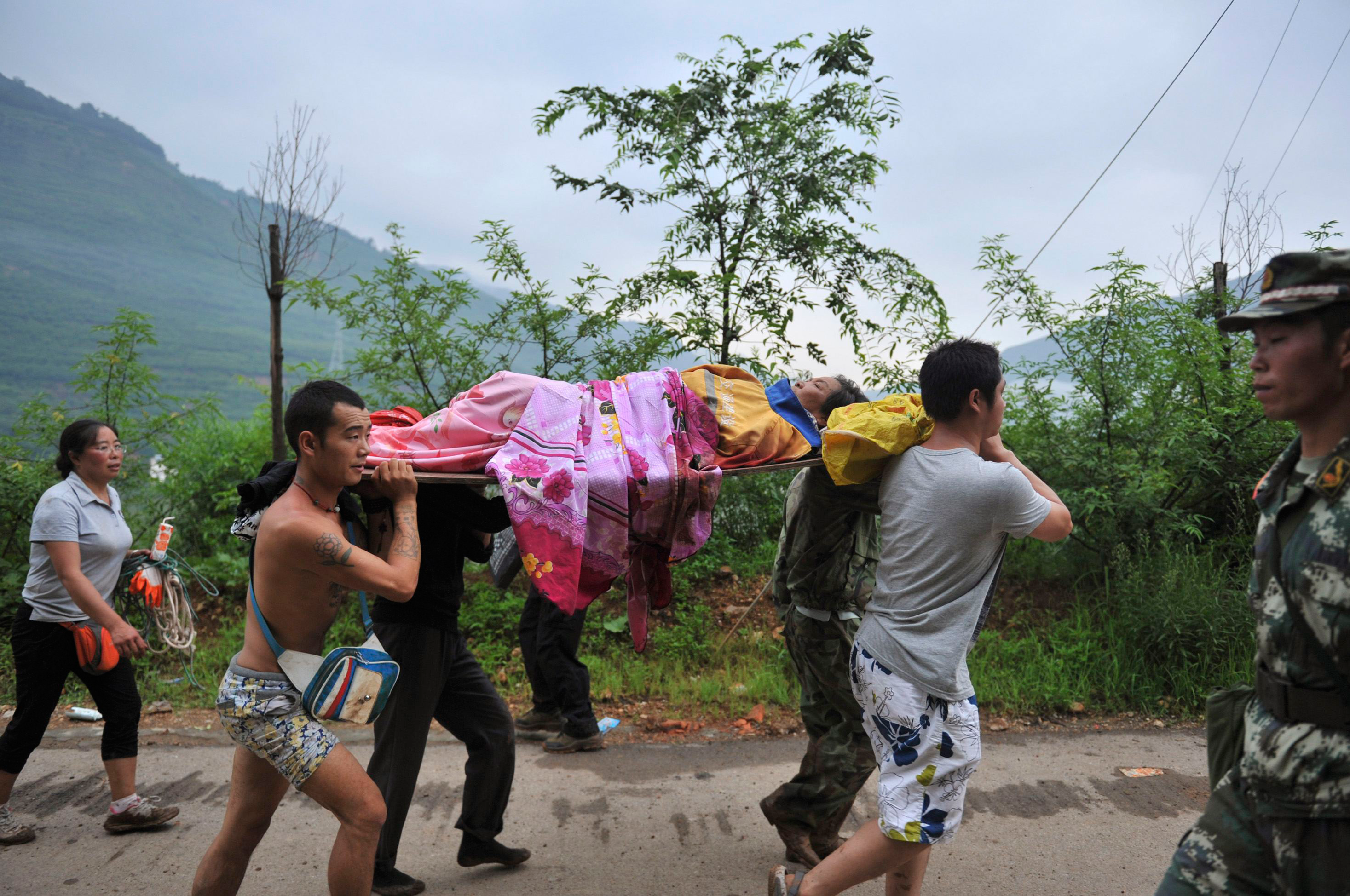 An injured person is evacuated after a magnitude 6.3 earthquake hit Longtoushan town, Ludian county, Zhaotong, Yunnan province