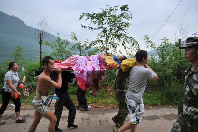 An injured person is evacuated after a magnitude 6.3 earthquake hit Longtoushan town, Ludian county, Zhaotong, Yunnan province 