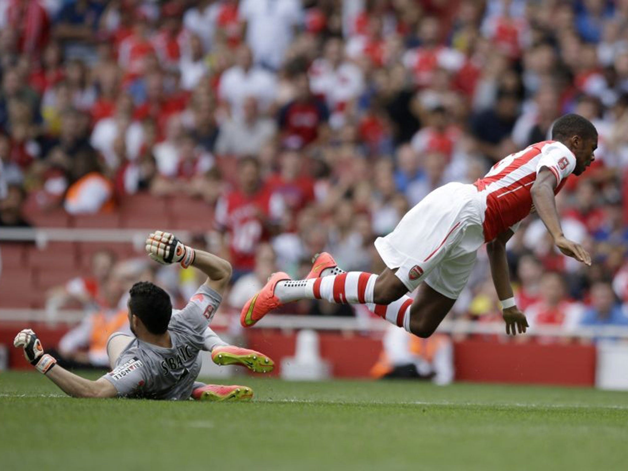 Chuba Akpom is brought down by Monaco goalkeeper Danijel Subasic during their 1-0 win over Arsenal at the Emirates Cup