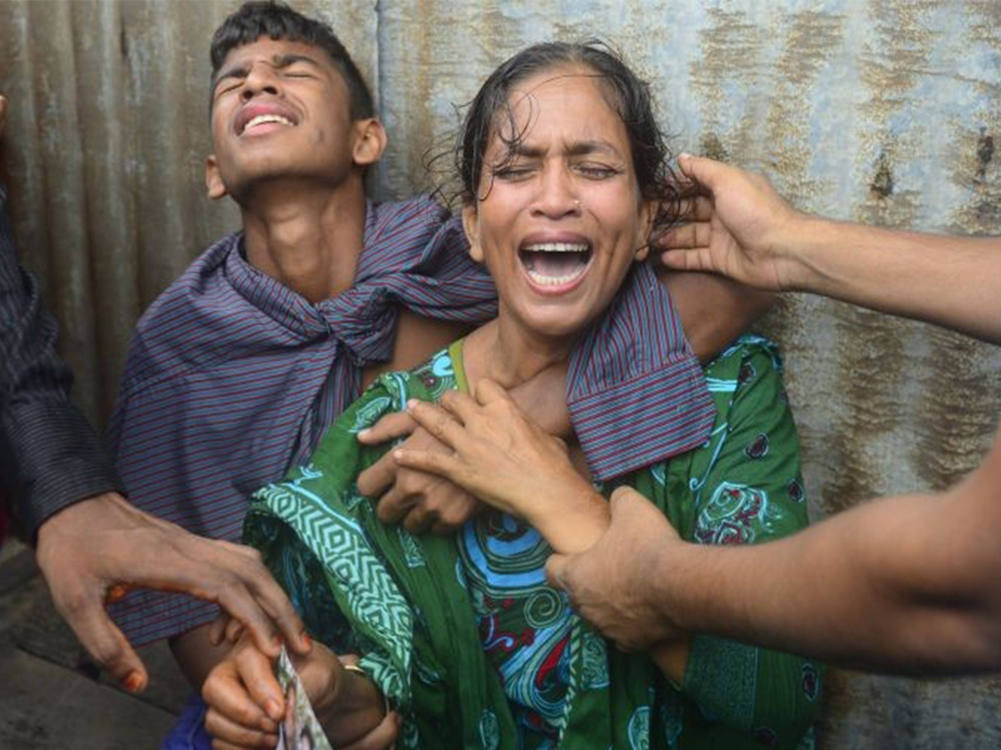 Bangladeshis mourn for their missing relatives after an overloaded ferry capsized in the Padma river in Munshiganj