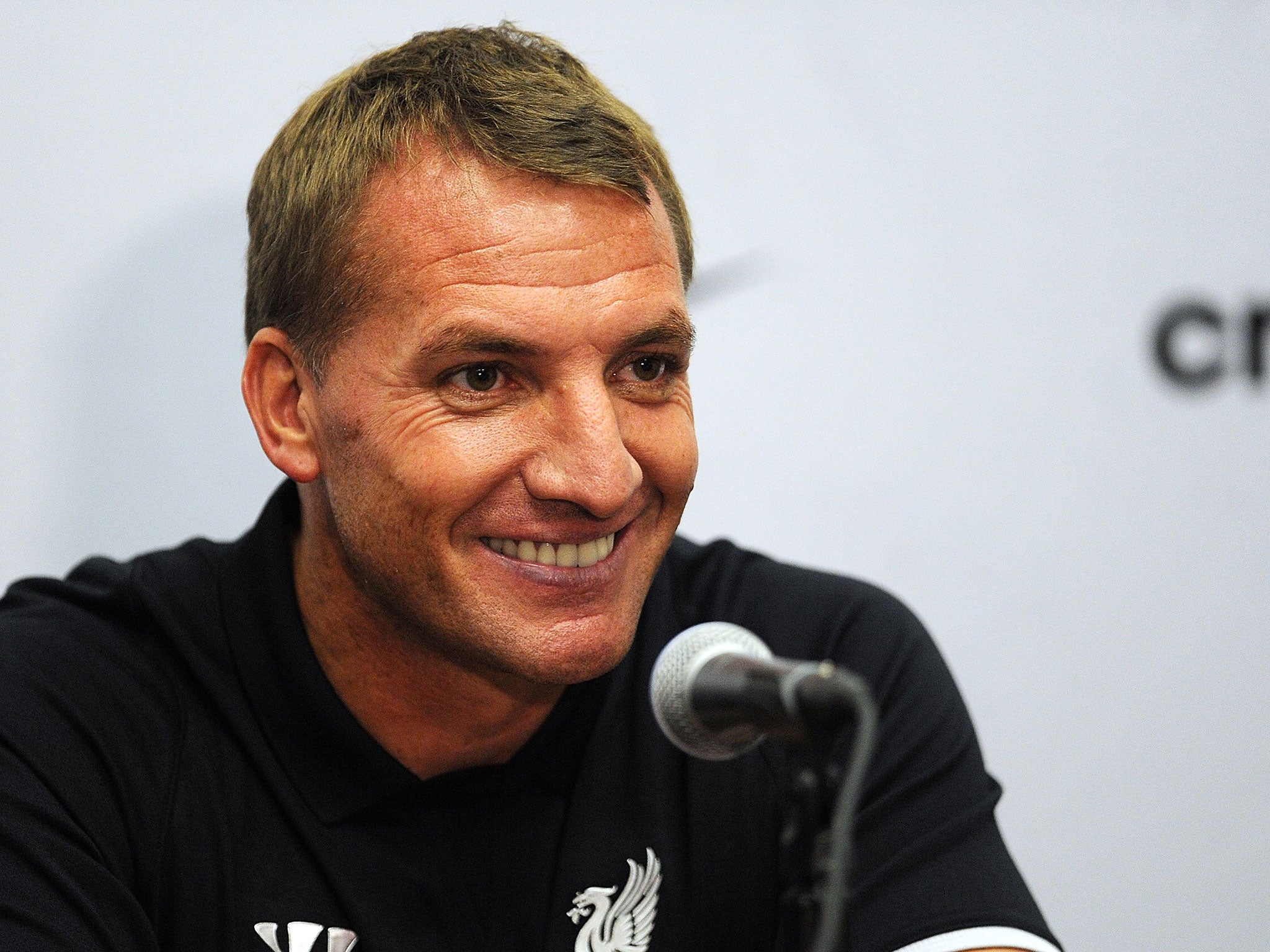 Brendan Rodgers smiles at a press conference