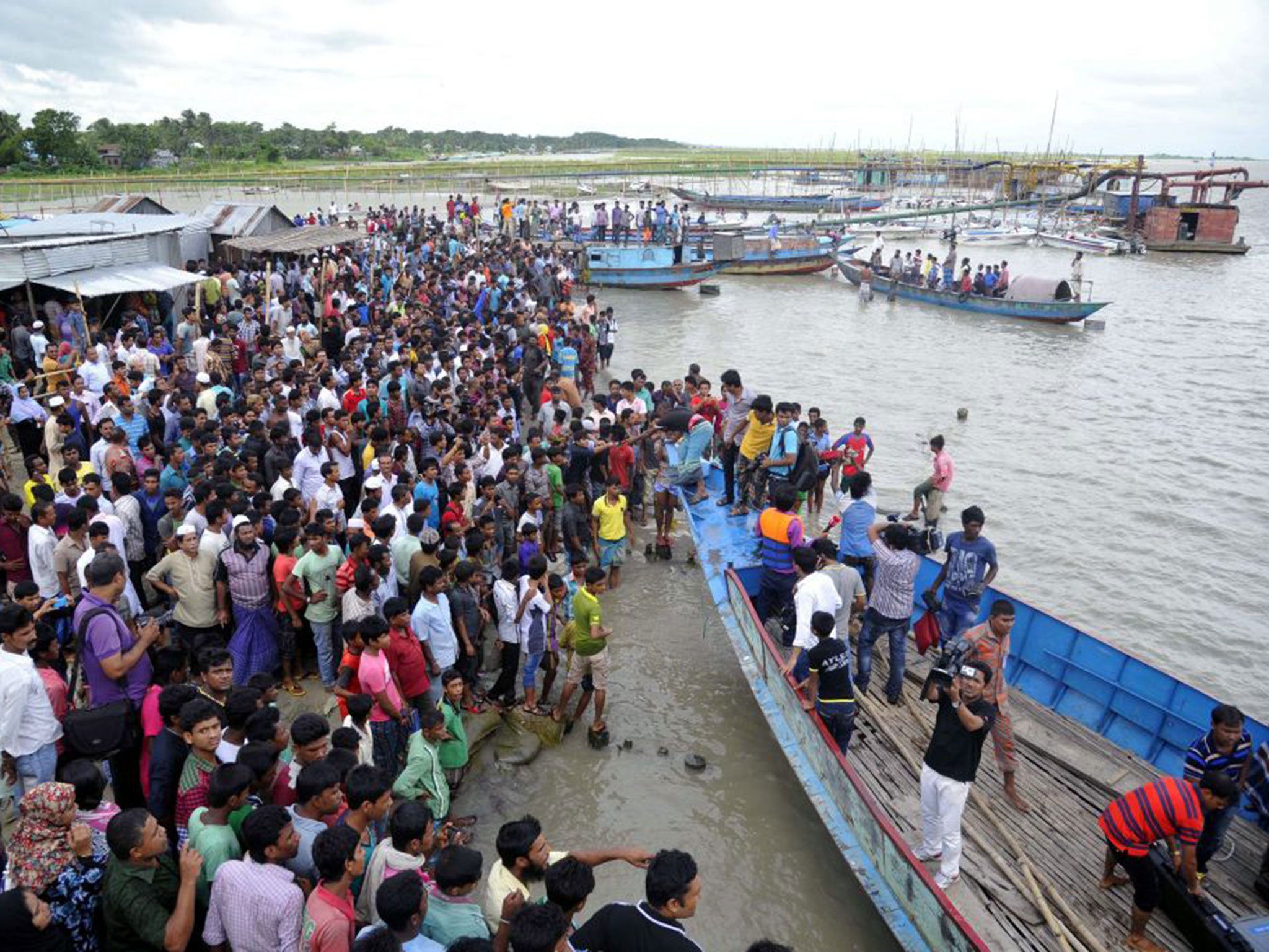 Locals and relatives gather to await news of survivors. The capsized ferry was carrying at least 250 passengers