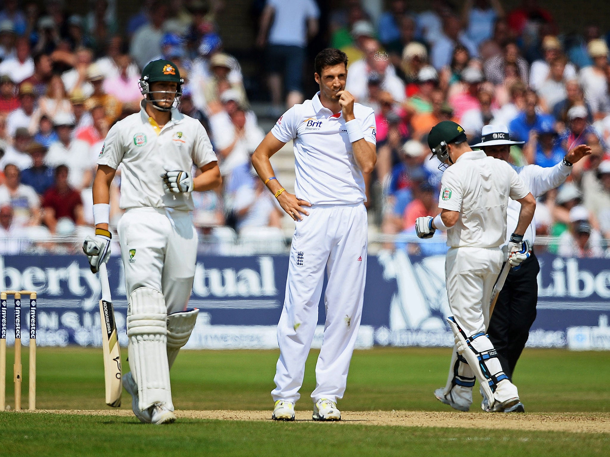 Steven Finn of England looks dejected as James Pattinson (left) and Brad Haddin plunder runs during an Ashes Test