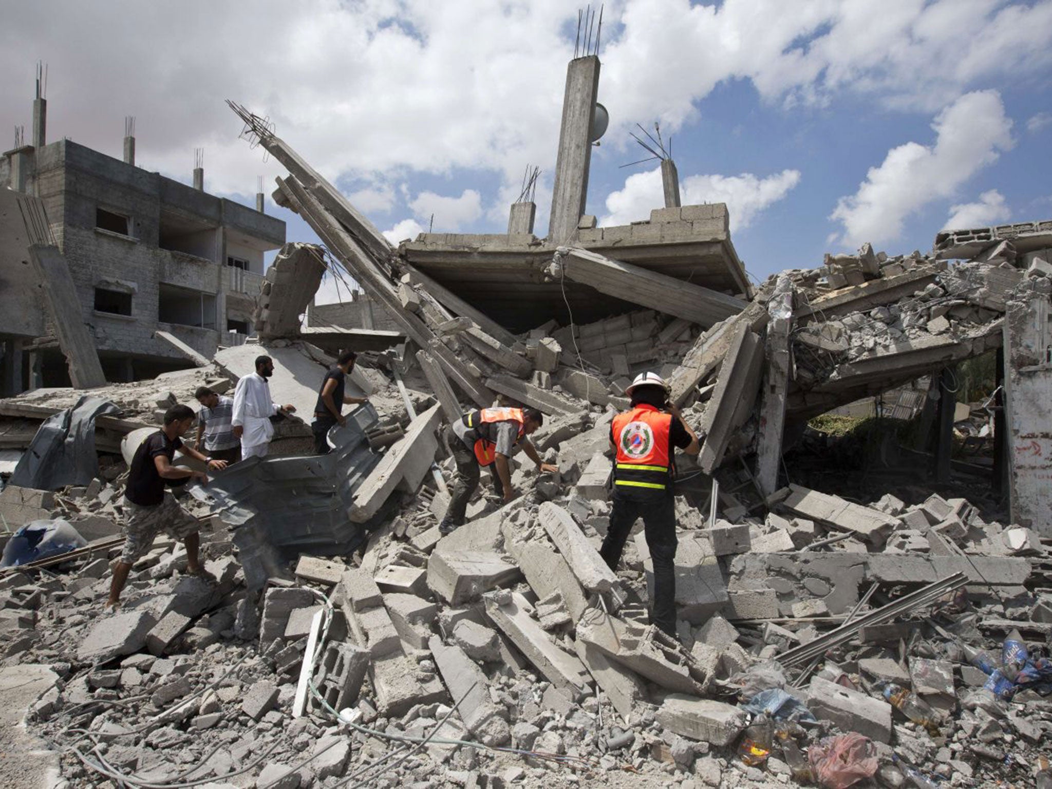 Rescue workers close to the Rafah refugee camp, where the entrance to a UN school was bombed on Sunday