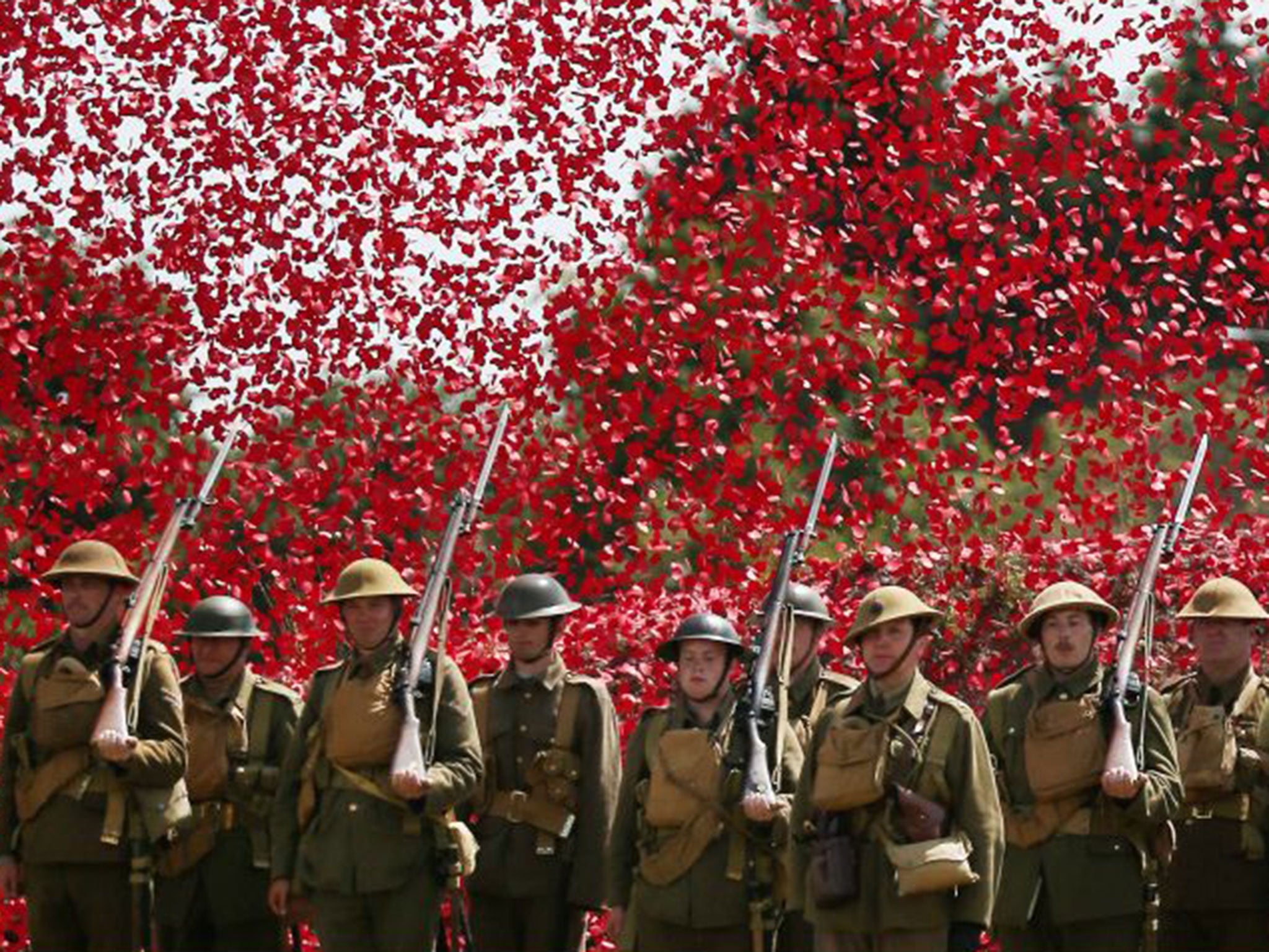 Members of the Great War Society in Bovington are showered with poppies during the day's commemorations