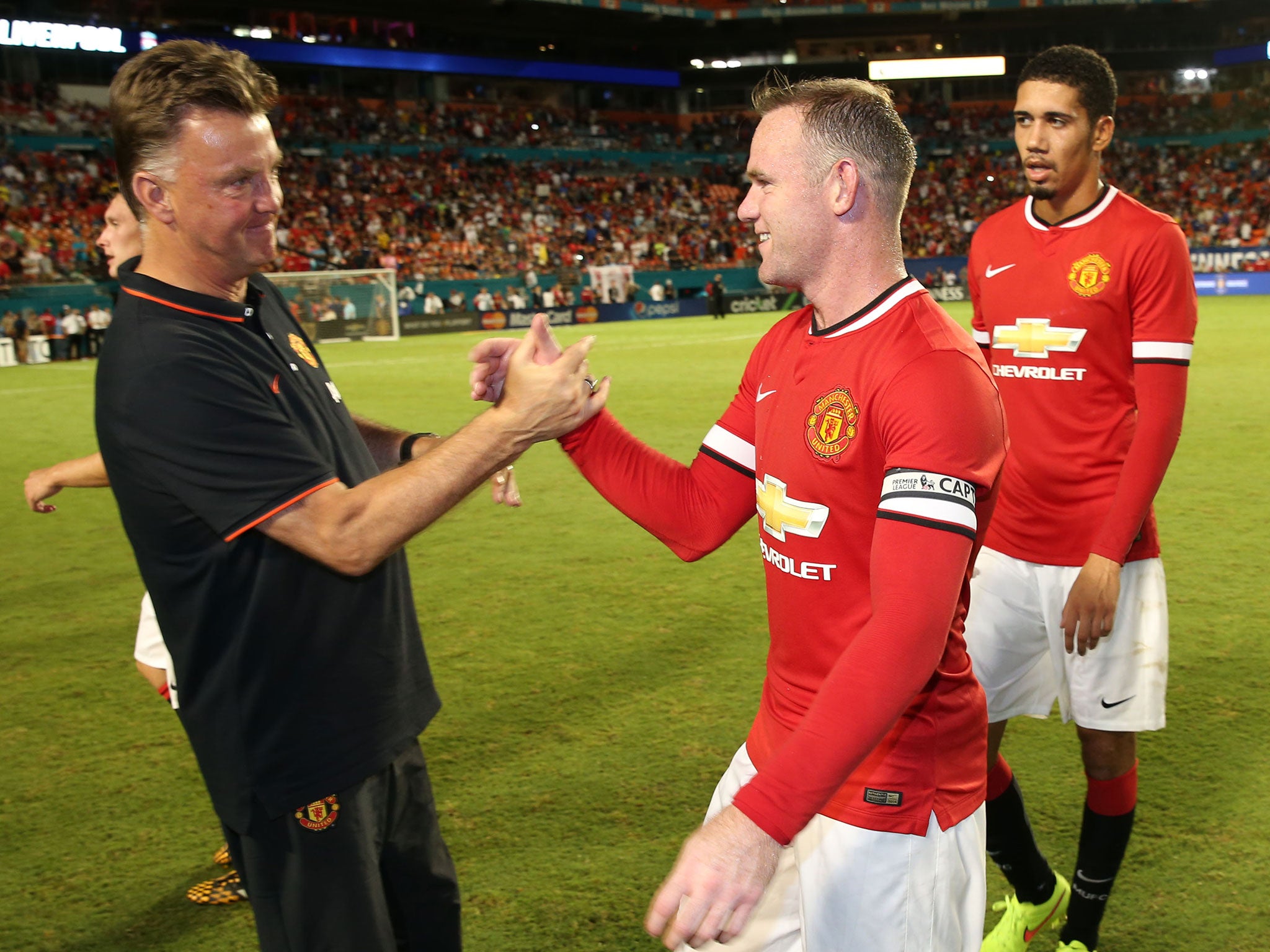 Louis van Gaal shakes Wayne Rooney's hand at full time after the Liverpool win