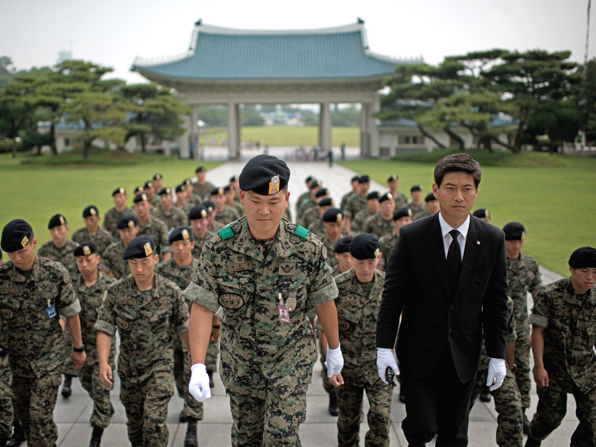 Soldiers pay their respects in June on the anniversary of the start of the Korean War. Many South Korean recruits are struggling with conscript life